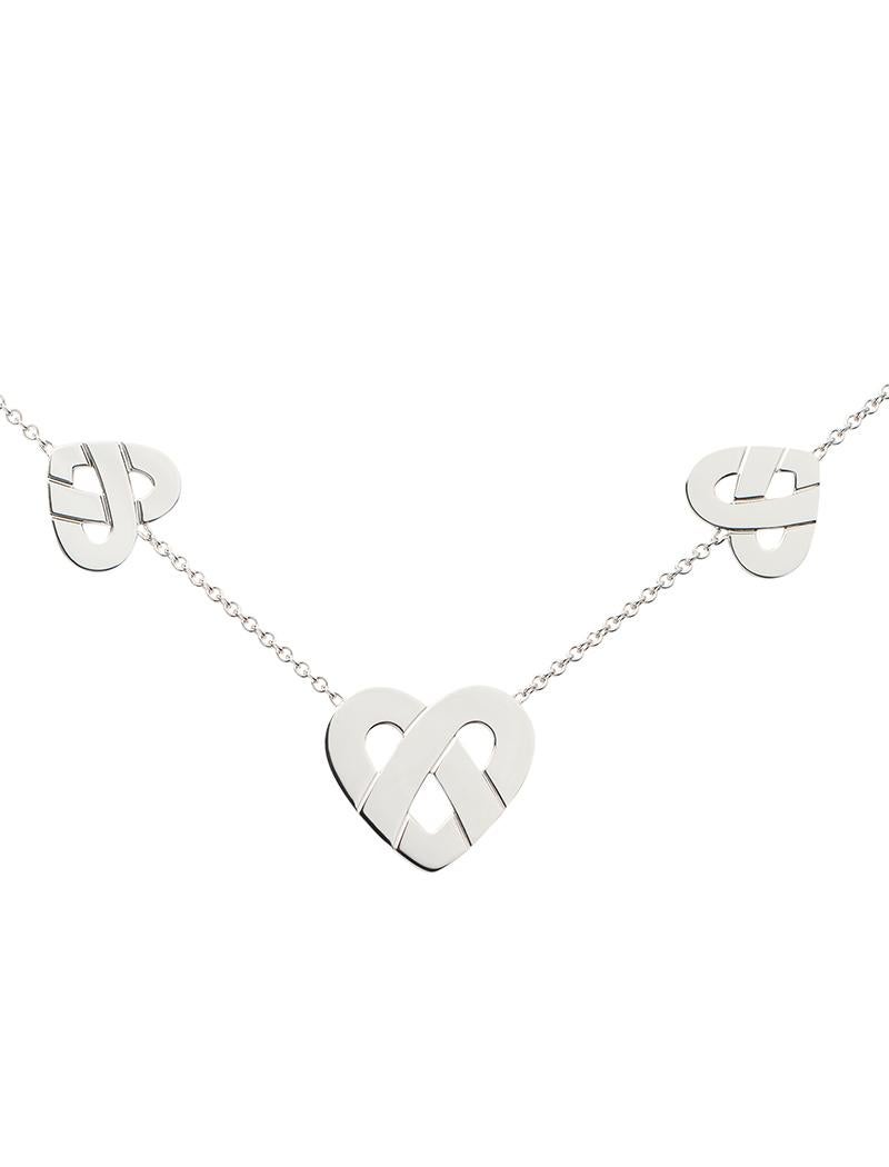 The timeless Poiray collection Cœur Entrelacé is revealed in pure lines, with generous curves, and is dressed in gold to celebrate all loves.

Interlaced heart necklace with three hearts on a white gold chain.

Please note that the carat weight,