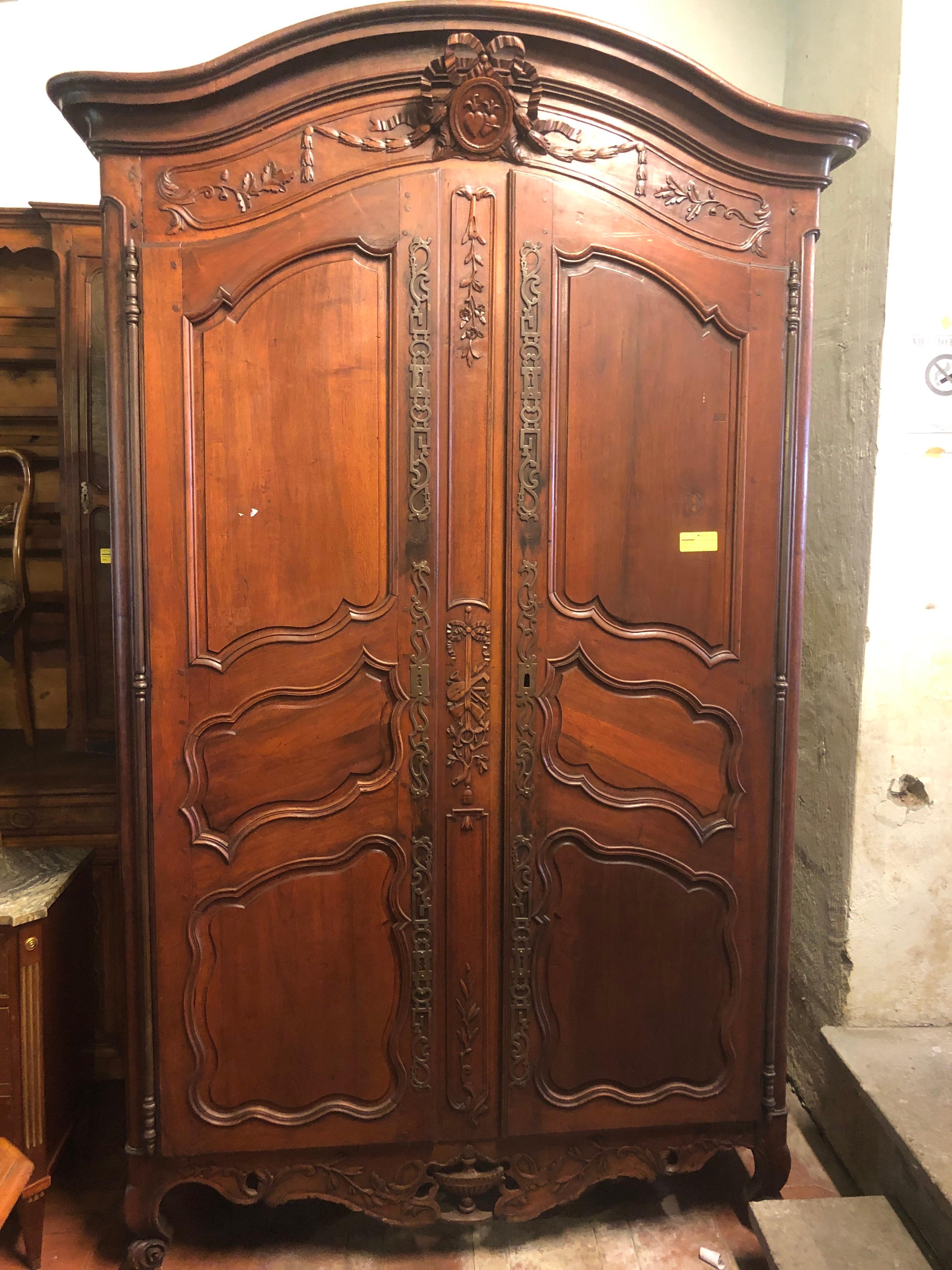Credenzas Provenzale wardrobe, of incredible workmanship, original hardware and of great workmanship. Carved walnut furniture, fantastic the love bow that embraces two choirs on the top of the hat. The base also has a fine carving. We are faced with
