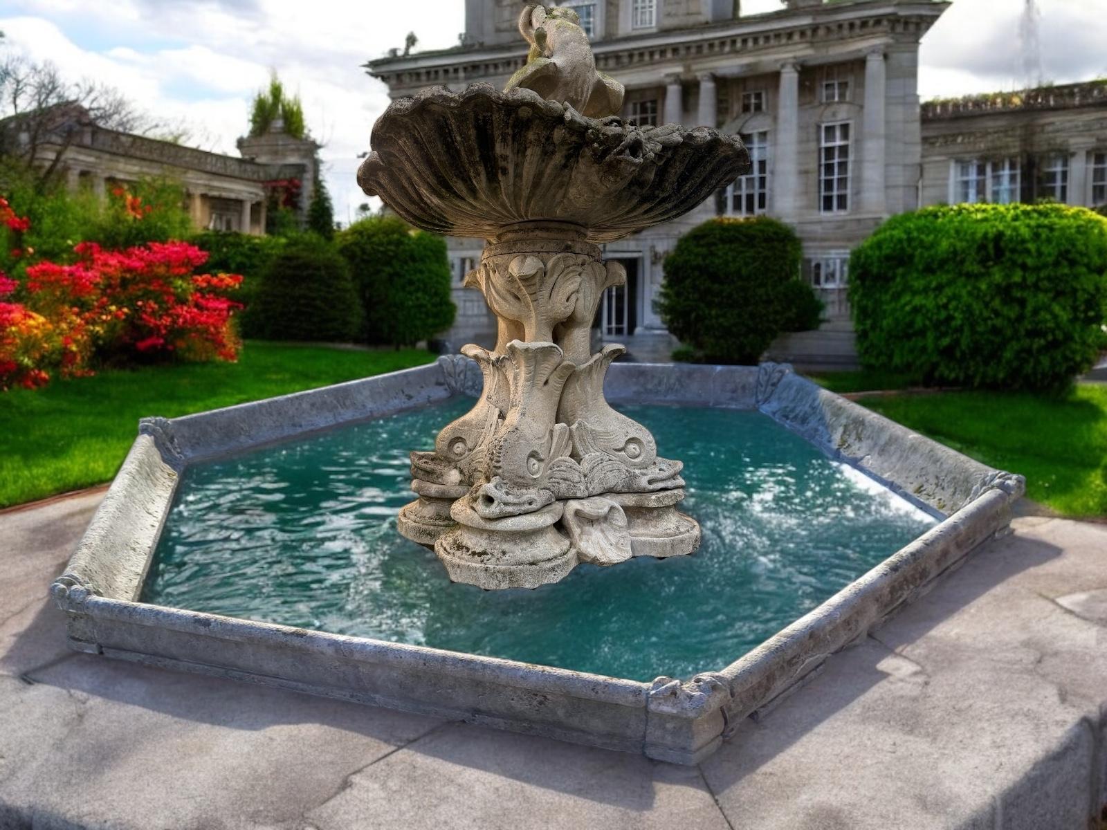This  rare 18' century  monumental finely carved limestone fountain is composed with three amazing dolphin  statues holding an outstanding shel -shaped basin  adorned with monster heads ending with a putto figure. Excellent decoration for your