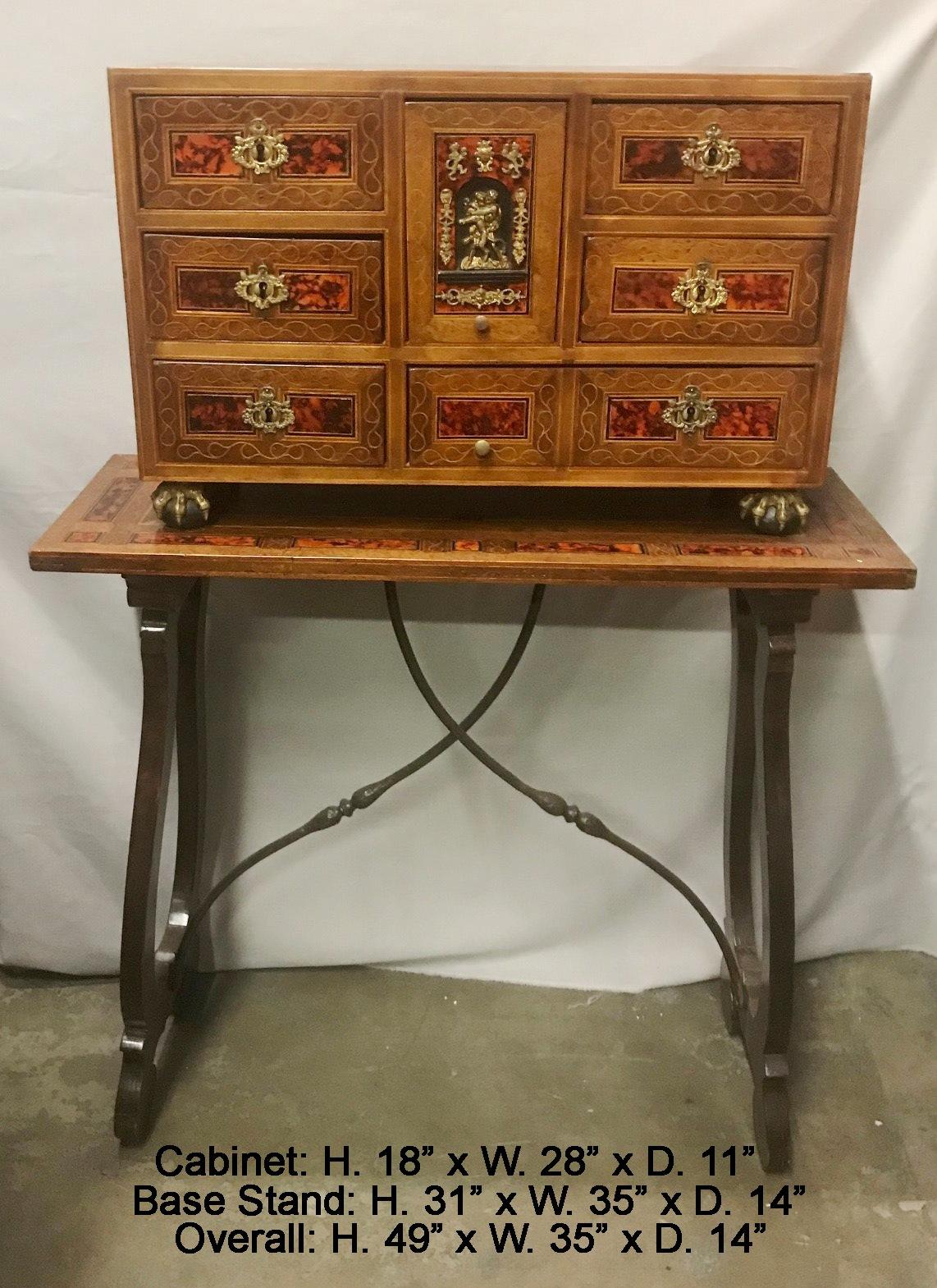 Remarkable 18th century Spanish baroque tortoise shell inlaid and brass mounted walnut cabinet on 19th century inlaid stand.
The cabinet centered with a compartment with bronze figure mounted door, flanked by three drawer each side and small drawer