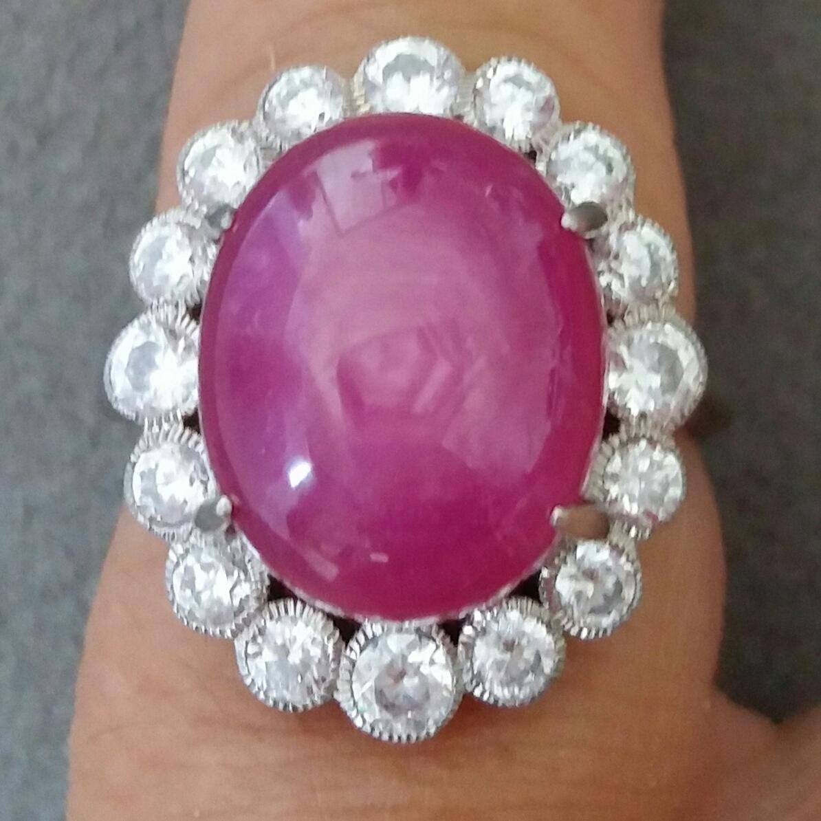 !8 carat burgundy color oval Ruby  cabochon ( 15 mm x 12 mm) set with 4,5 grams of 14 kt.white gold, 16 round full cut diamonds of 0,05 ct each = 0,8 ct total diamond weight

Ring Shank Diameter 21 mm
Height  28 mm
Weight  8 grams
In 1978 our