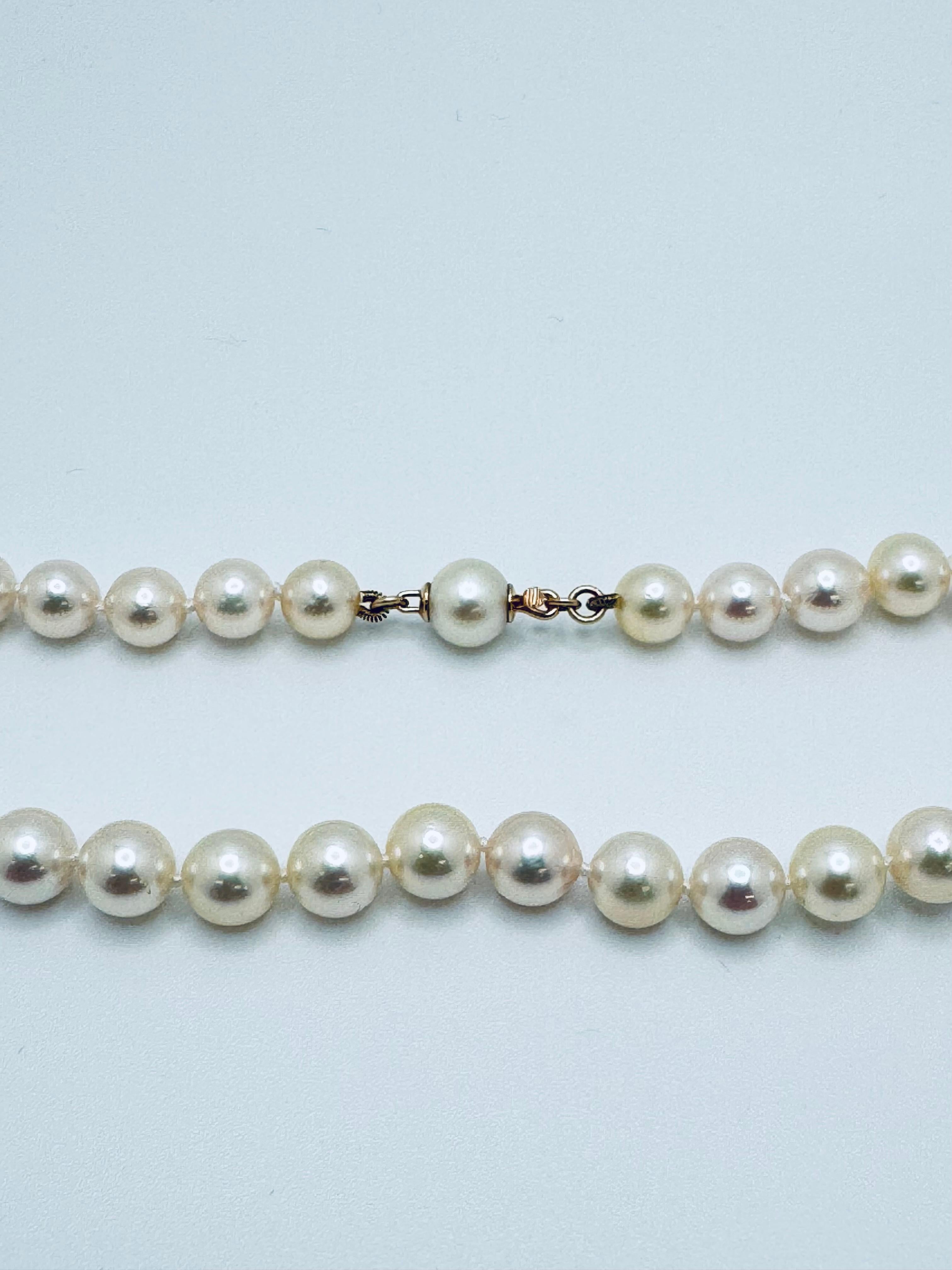 This elegant 18-inch necklace features cream-colored cultured freshwater pearls, each individually knotted for added security and a refined finish. The pearls are round in shape, offering a classic and timeless appearance with soft luster and subtle