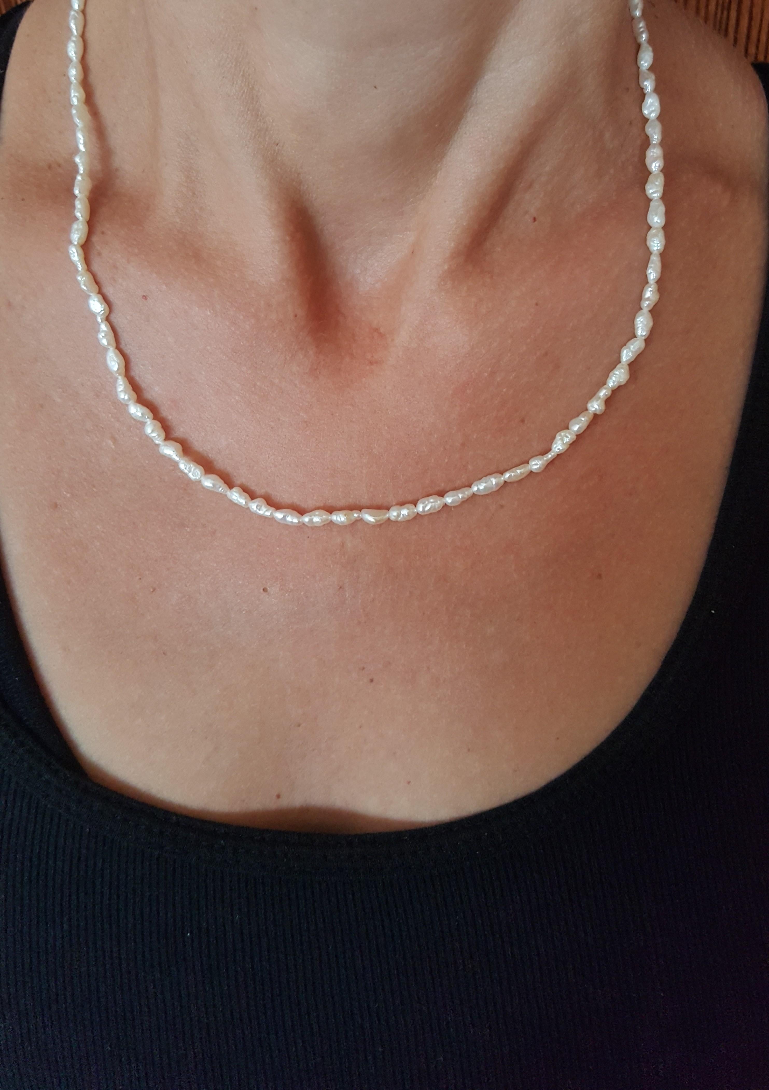Eighteen-inch white freshwater pearl strand with 14kt yellow gold pearl clasp. The 3mm pearls have lustrous clean nacre. The lovely strand can be worn separately or layered with other necklace strands. Please let us know if you have any
