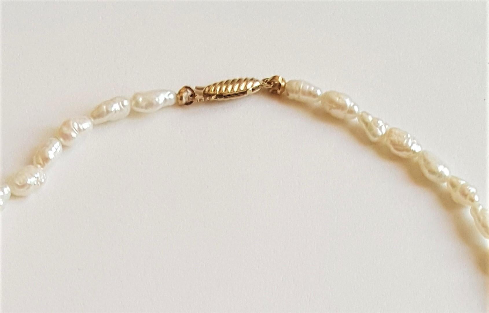 Uncut White Freshwater Pearl Strand with 14kt Yellow Gold Pearl Clasp For Sale