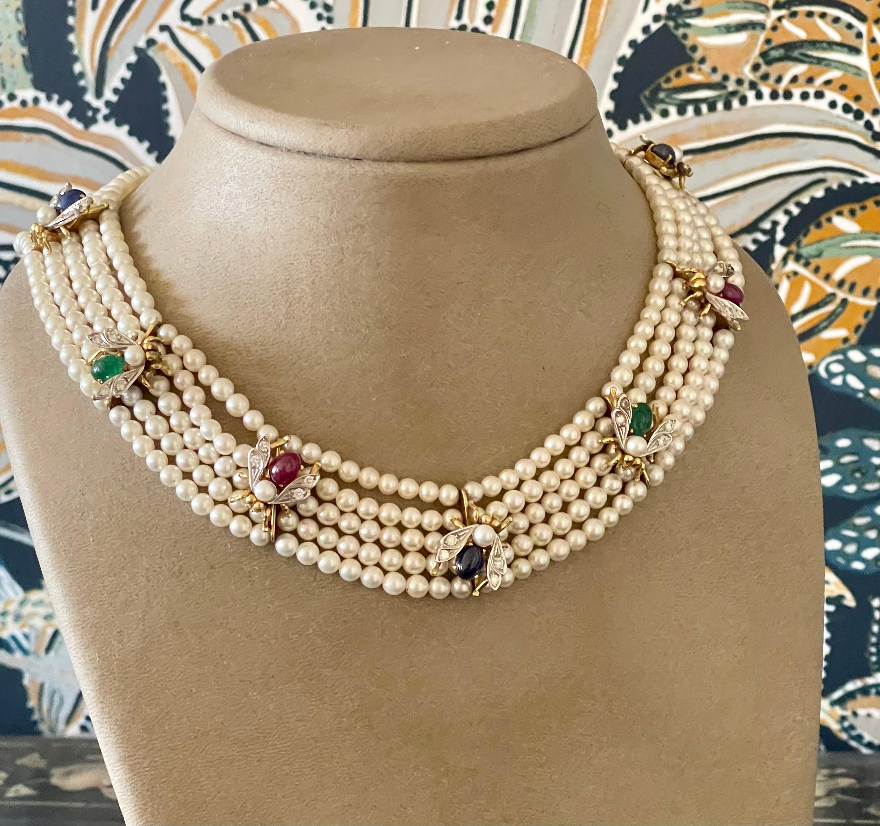 A delightful Vintage Choker necklace from the 1950s in 18 K yellow Gold featuring 5 strands of cultured pearls (4-4.5mm) . The necklace is decorated with 7 bees in 18 K yellow Gold. The body of the bees consists of Sapphire, Rubies and emeald