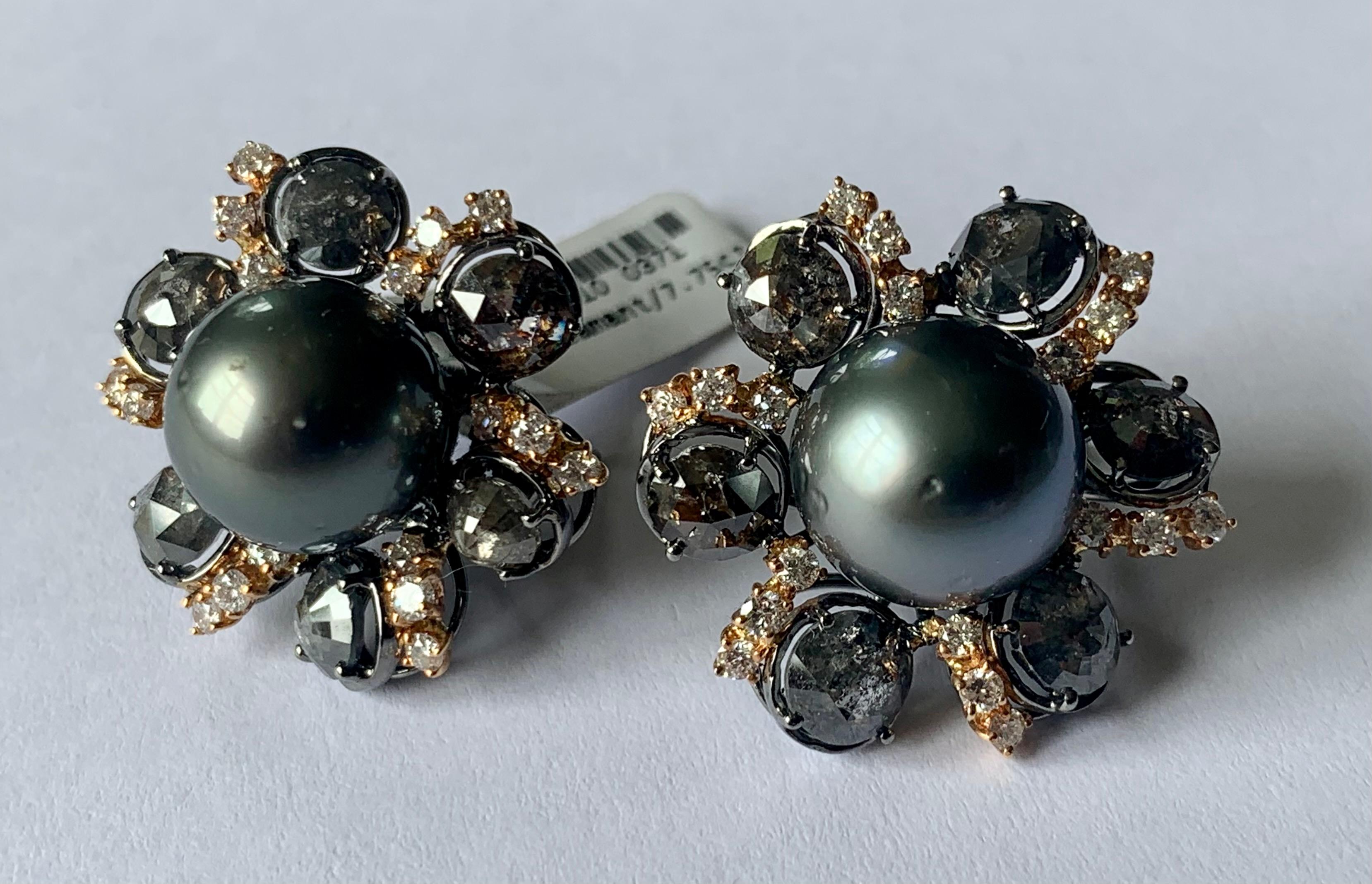 Very unusual 18 K blackened white Gold and pink Gold omega clip post earrings featuring 2 silvery Tahitian Pearls (12.2 mm and 12.5 mm). They are accentuated by 12 rough Diamonds with a weight of 7.75 ct and 36 Brilliant cut Diamonds weighing 1.06