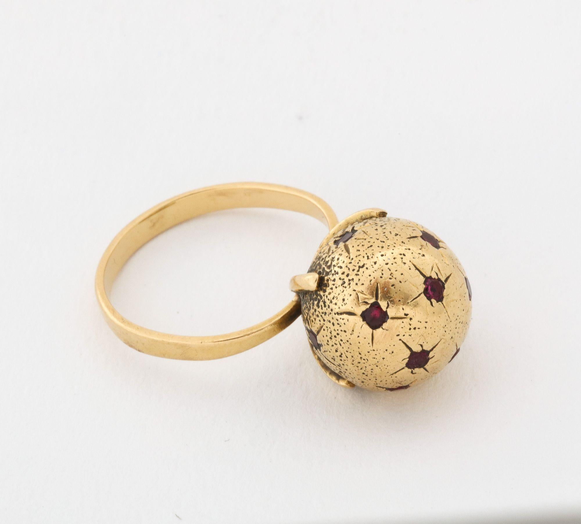 A very wearable 18 k Gold Globe Ring with Rubies set in the star. Very chic size 7 and can easily be sized to fit