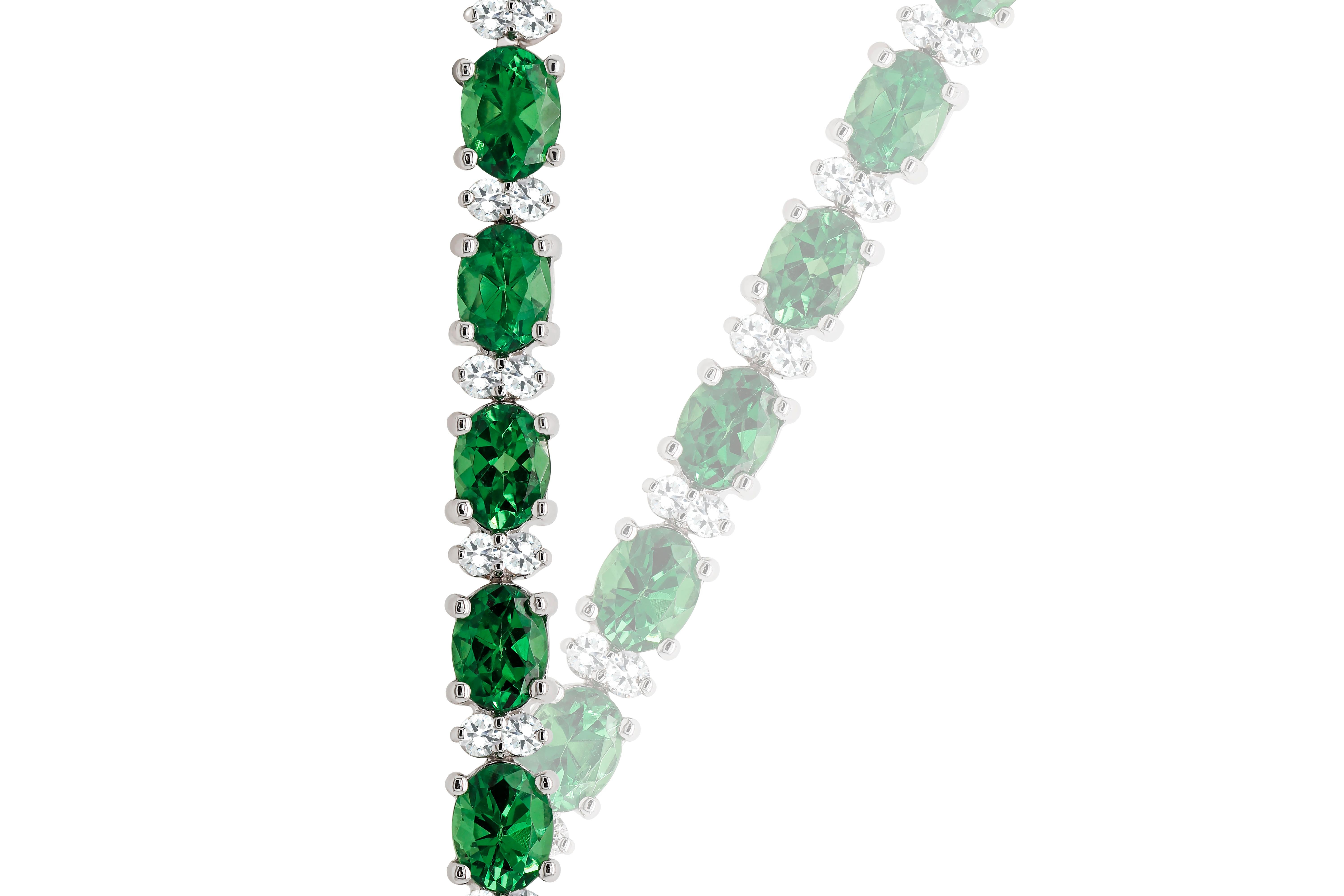 A fabulous grassy green Tsavorite and diamond solitaire tennis bracelet in 18K Gold.

Each Tsavorite is spaced by two sparkling diamonds which highlights make them more glorious and vibrant in their look. A delicate heart-shaped clasp completes the