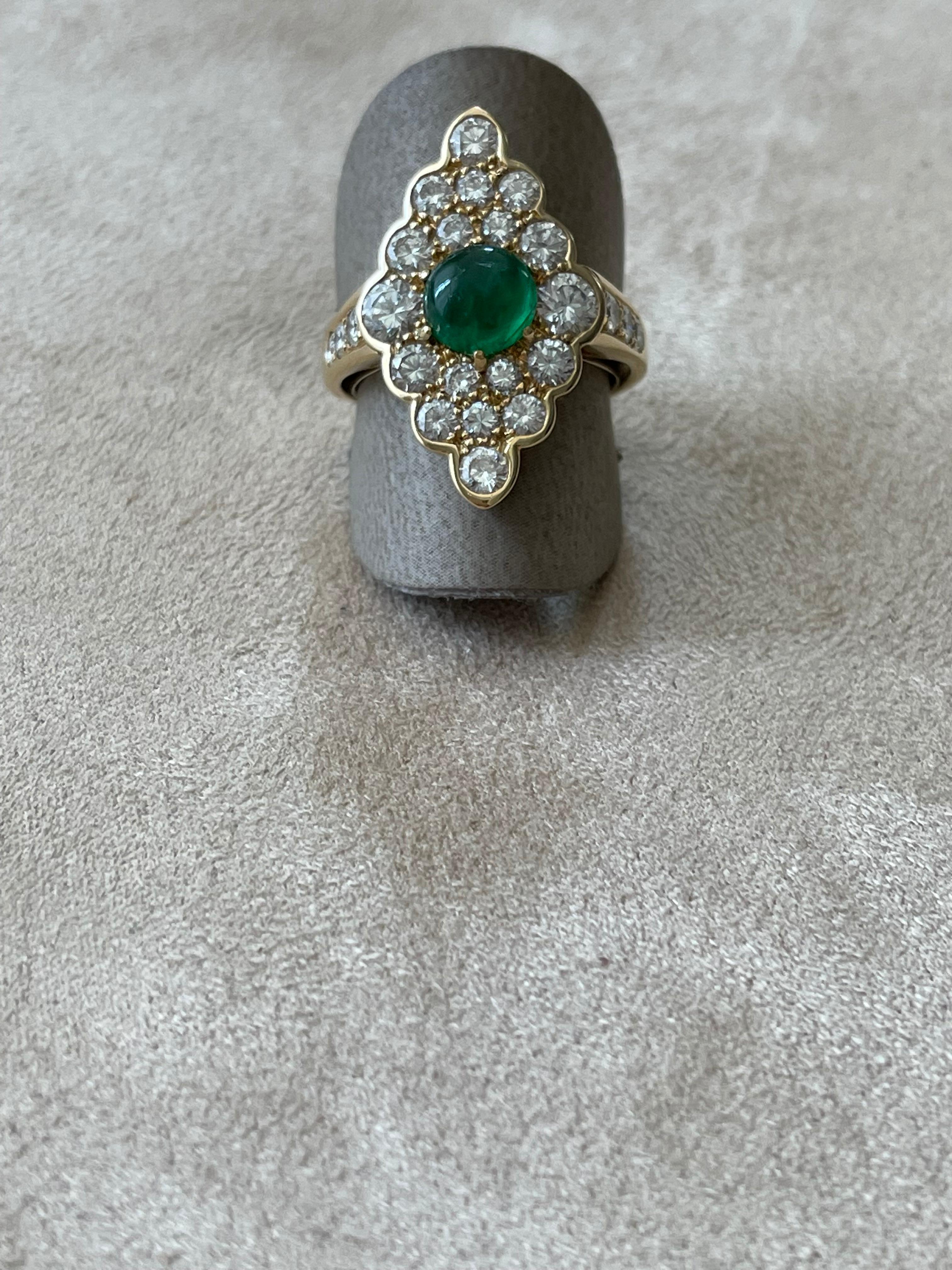 Vintage Ring reminiscent the Victorian style in 18 K yellow Gold set centrally with a Emerald Cabochon weighing approximately 1.20 ct and surrounded by 25 brilliant cut Diamonds , G color, vs clarity weighing approximately 2.50 ct. 
The ring is
