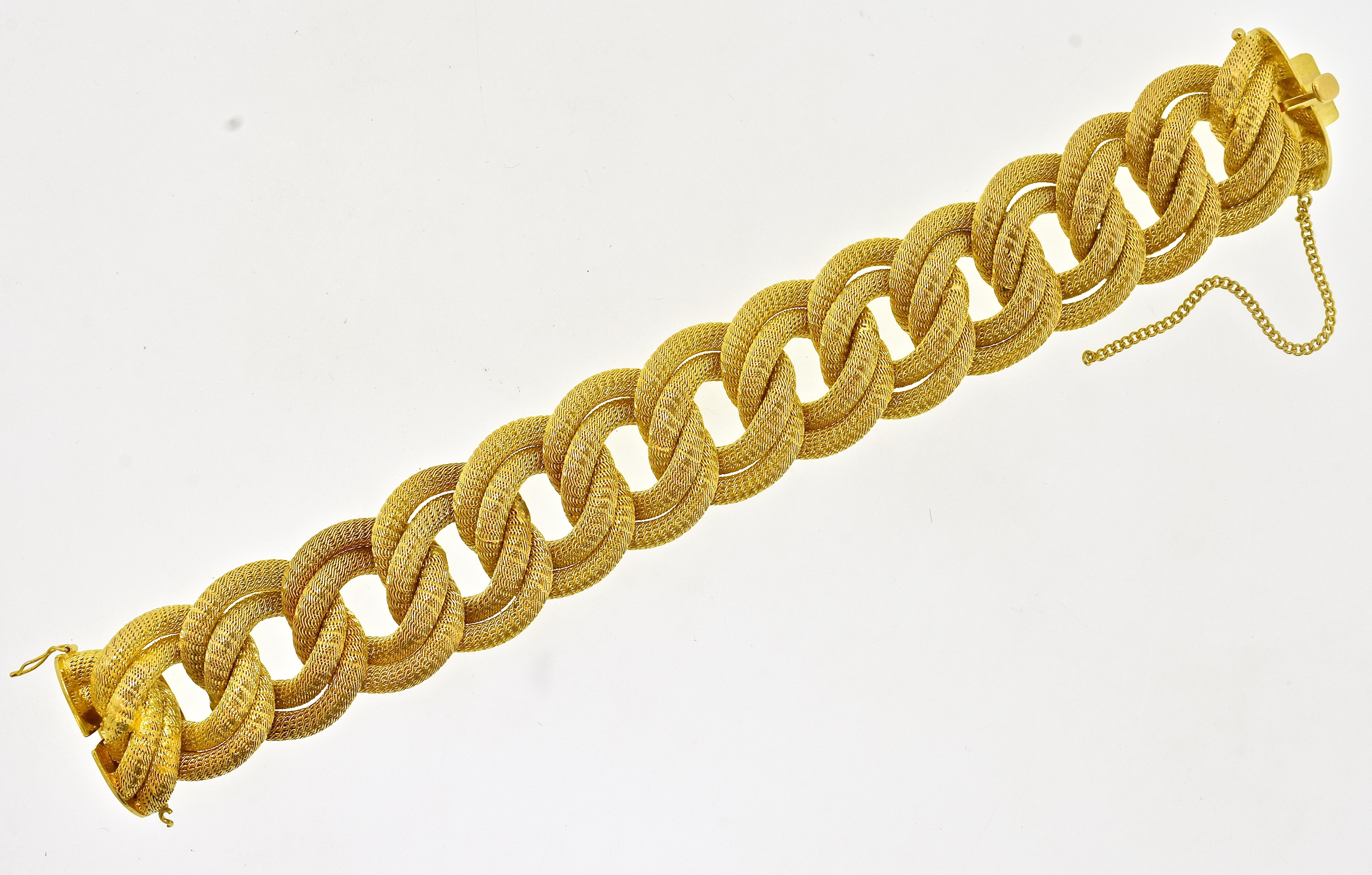 Vintage bold woven link 18K bracelet weighing 89.09 grams, width of 1.1/8th inches and a length of 8 inches.  One of the most appealing aspects of this bracelet is its bright, vivid, rich yellow gold color.  Made circa 1960 in Europe with European