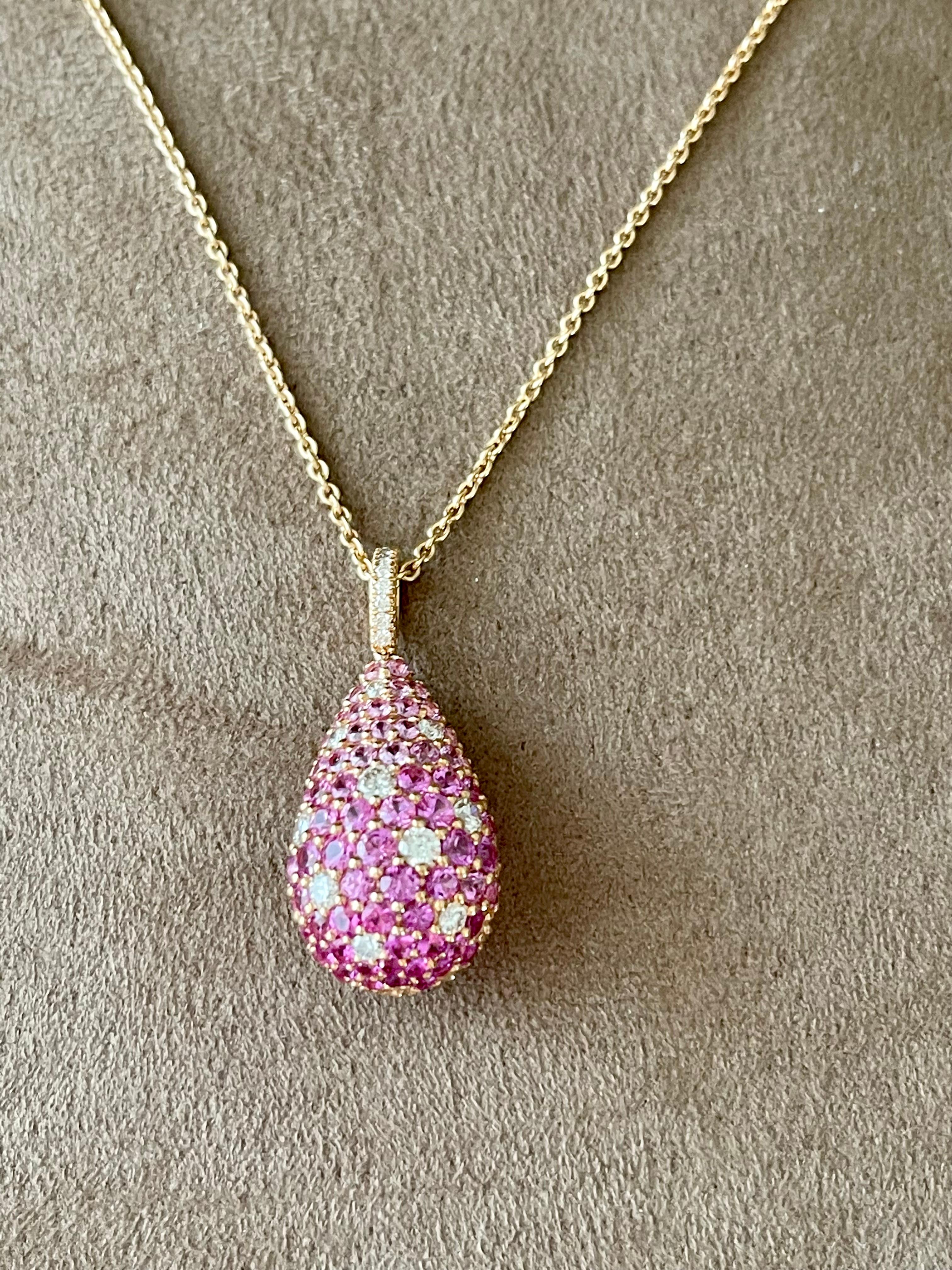 Very attractive bombé style pendant pavé set with 71 pink Sapphires weighing 3.06 ct and 17 brillinat cut Diamonds weighing 0.55 ct, G color, vs clarity.
Length of the chain 40 cm. Dimensions of the pendant: 3.1 cm x 1.4 cm. 
Masterfully handcrafted