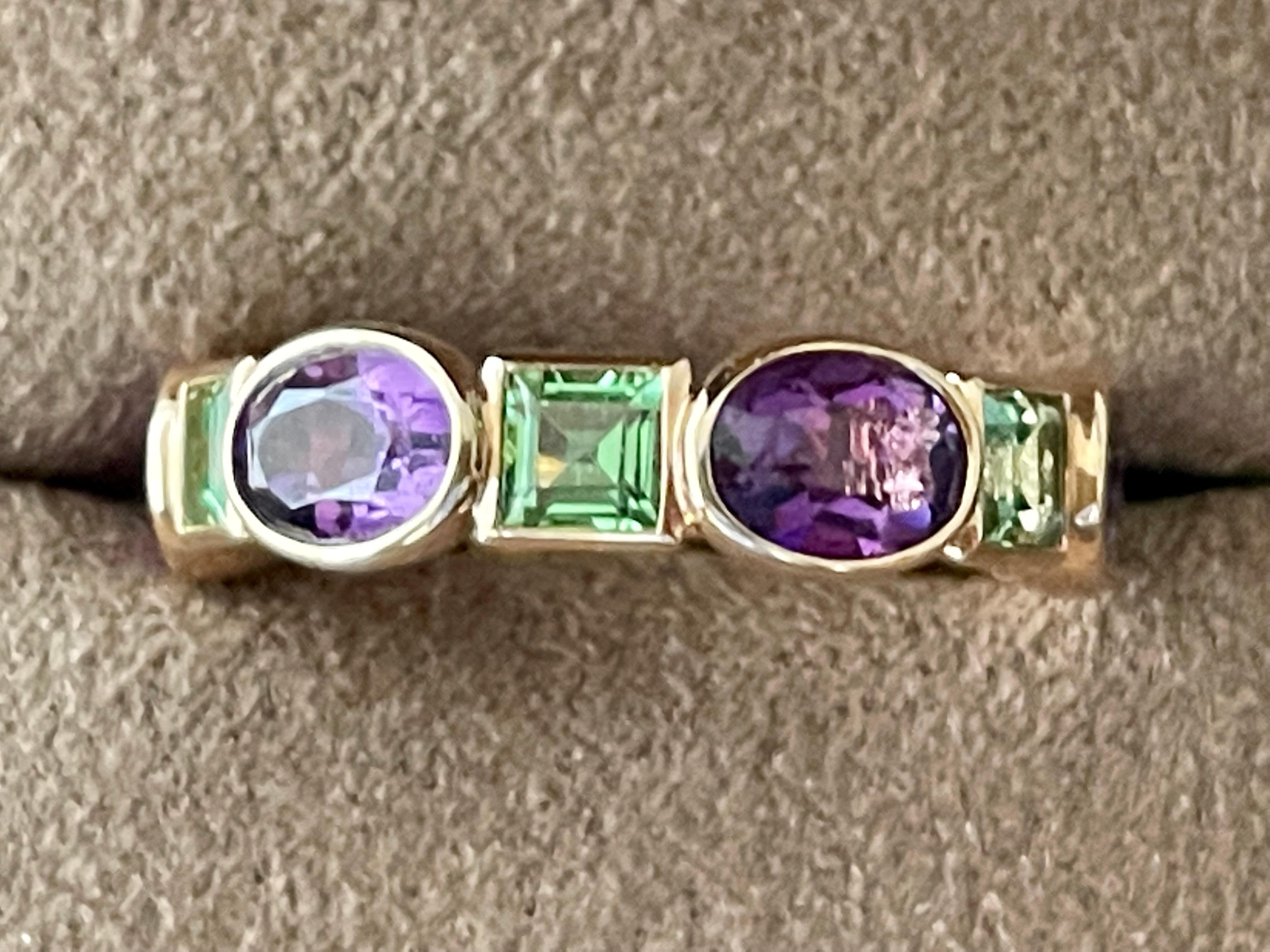 Modern and solid 18 K rose Gold eternity band featuring 6 oval bezel set Amethyst with a total weight of 4.33 ct and 5 square cut Tsavorites weighing 2.38 ct. 
The ring is currently size 55/15 ( american ring size 7.5) but can be resized smaller to