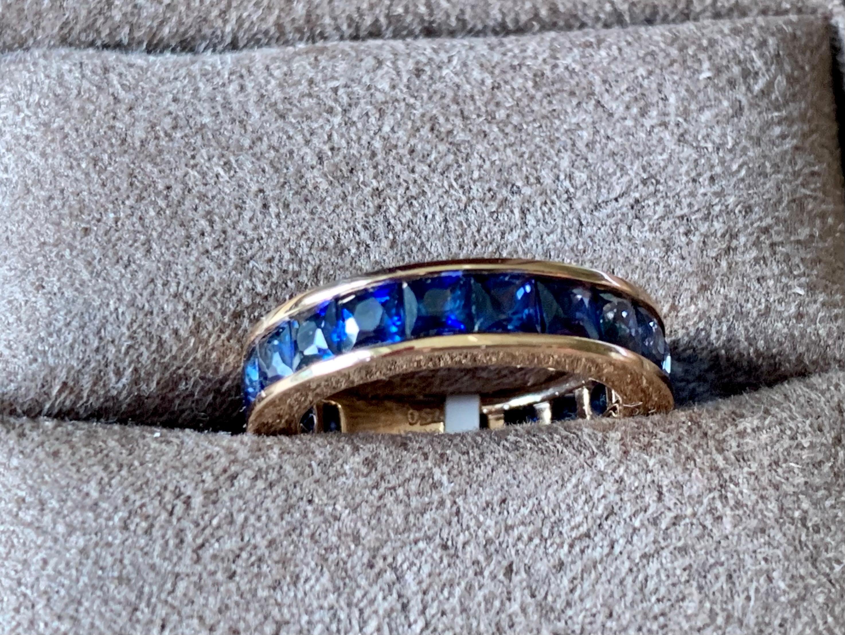 Solid 18 K rose Gold Eternity Ring set with 18 square cut french cut blue Sapphires in a channel setting. 
Each  stone is faceted and well-matched in shape and color. Natural variations in hue and intensity add to the beauty of this ring. Wear it