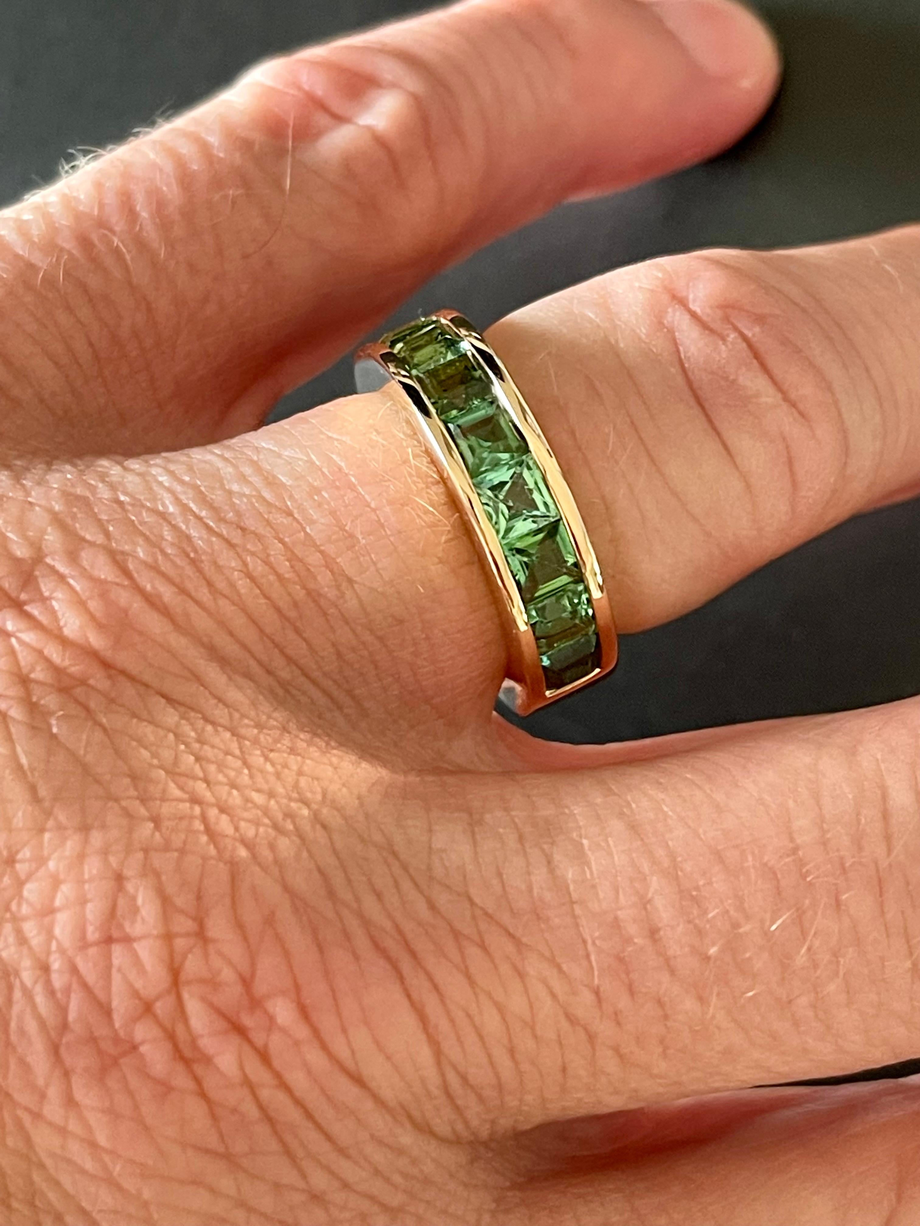 Solid 18 K rose Gold Eternity Ring set with 10 square cut Mint Green Tourmalines weighing 3.29 in a channel setting. 
Each  stone is faceted and well-matched in shape and color. Natural variations in hue and intensity add to the beauty of this ring.