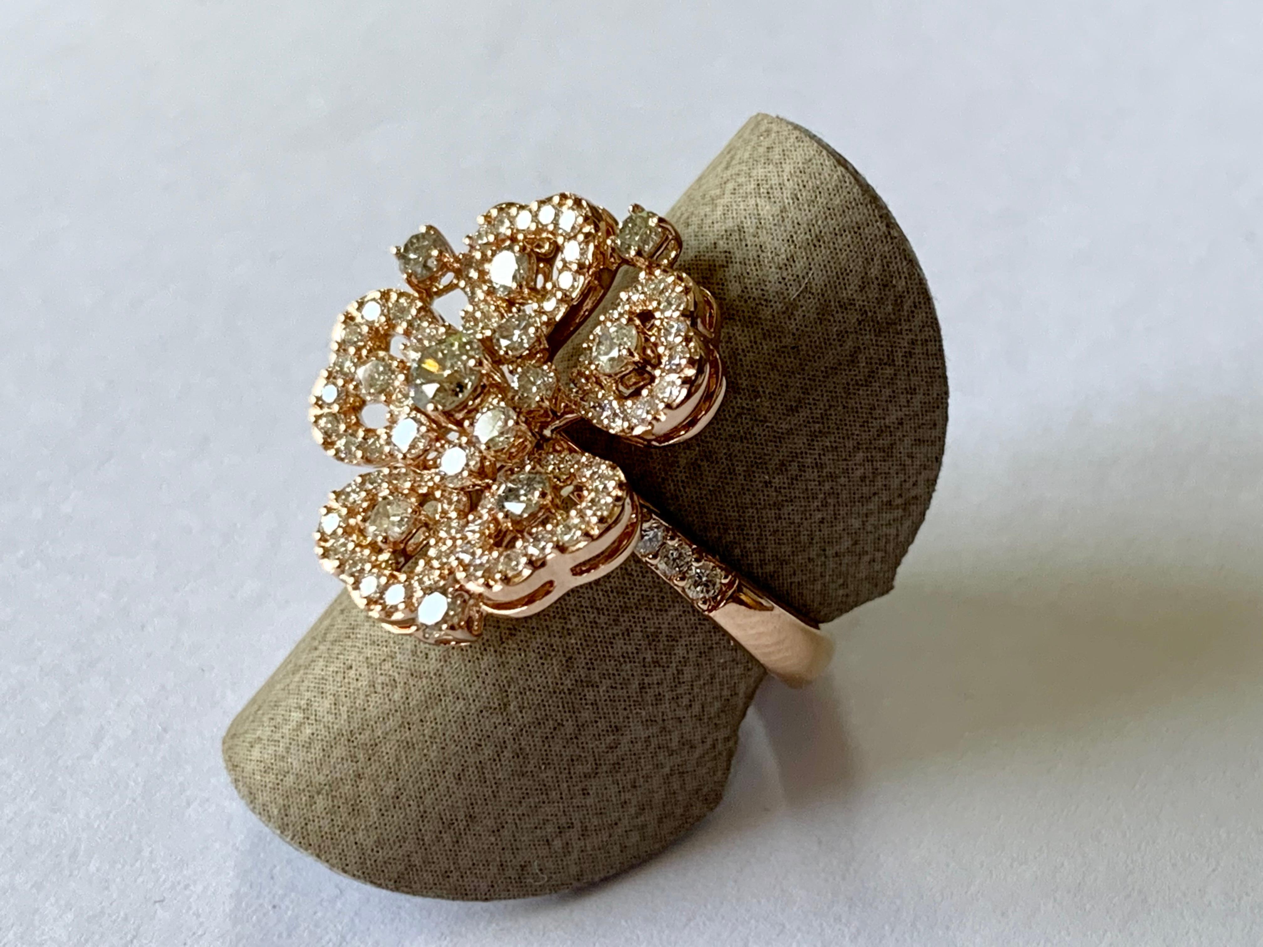 Romantic flower Ring in 18 K rose Gold set with 95 Champagne colored and white brilliant cut Diamonds weighing 1.55 ct. Matching dangle earrings and pendant available.
The ring is currently size 6.5 but can be resized easily. 