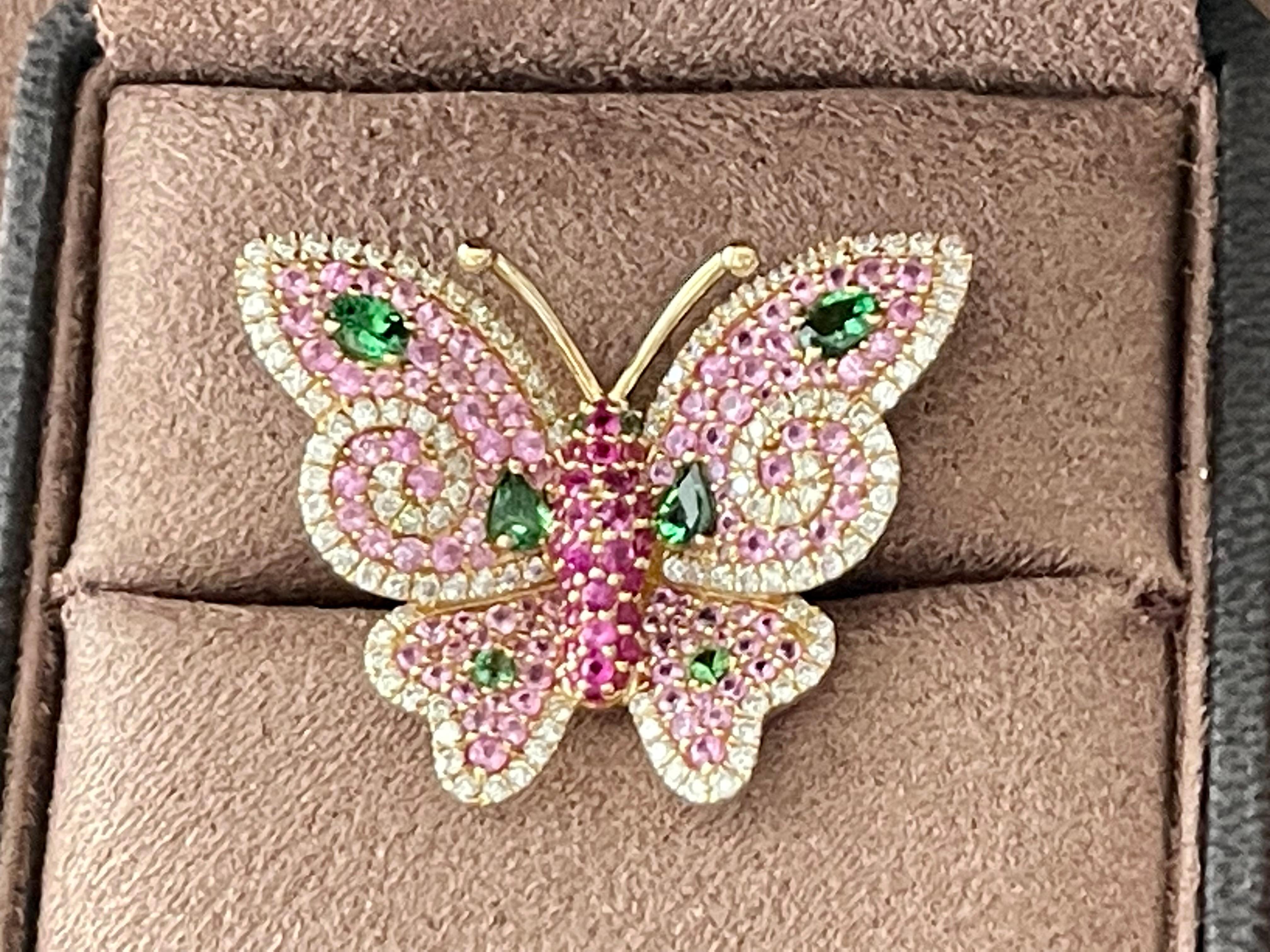 Fantastic 18 K rose Gold Butterfly Ring. This butterfly is ready to take a flight covered with precious gems. The butterfly is covered with 29 pave set Rubies 0.48 ct, 106 pink Sapphires 1.69 ct, 8 vivid Tsavorites 0.79 ct and 114 brilliant cut