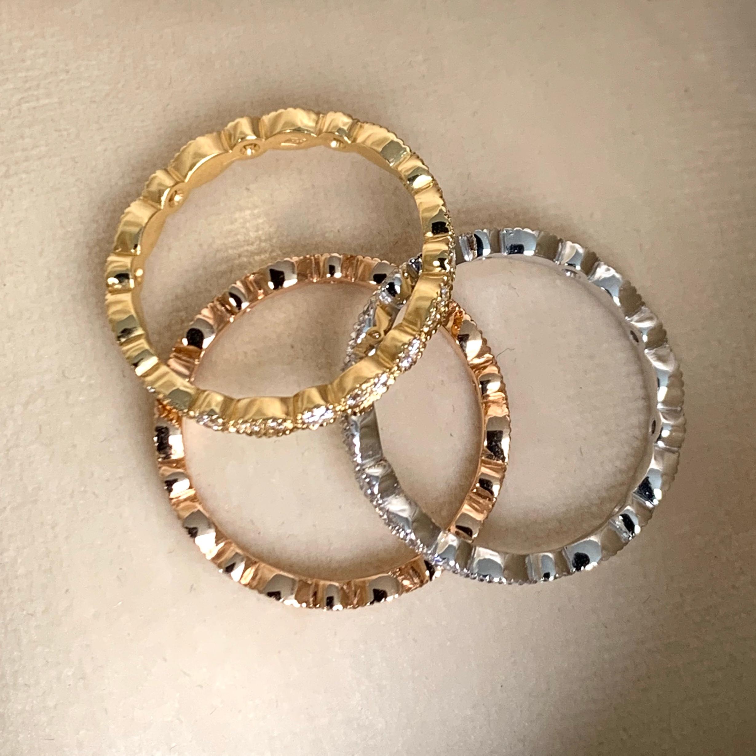 Round set eternity rings handmade in Belgium the traditional way , no casting involved. With traditional milgrain edging. Creating these rings was a very labor-intensive process, the rings are sawn out of the metal and the milgrain edges are made by