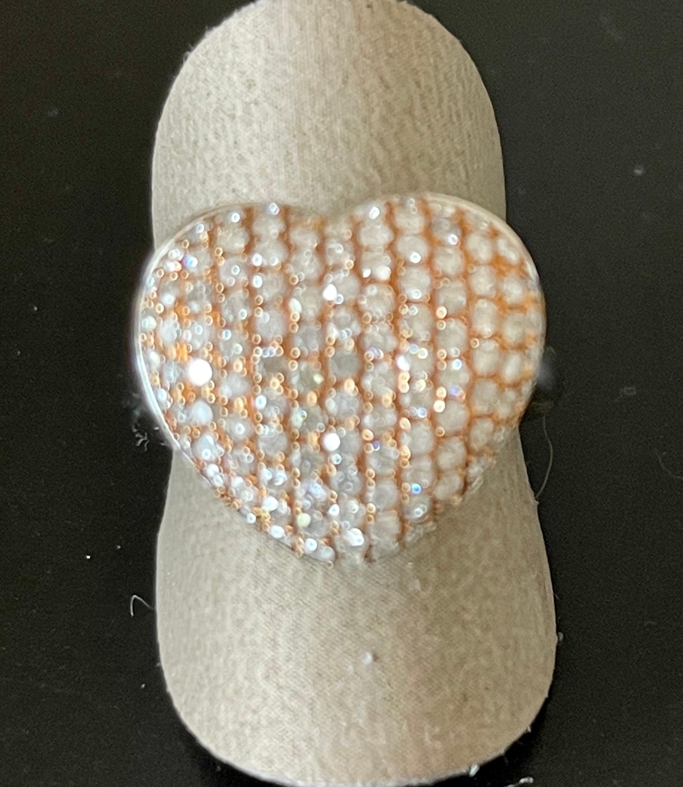 18 K white and rose Gold Ring pave set with 111 roundbrilliant cut Diamonds with a total weight 0f 1.27 ct. In the shape of a heart, slightly curved. 
The current ring size is 55 ( US size 7 1/2) but can be resized easily. 
Masterfully handcrafted