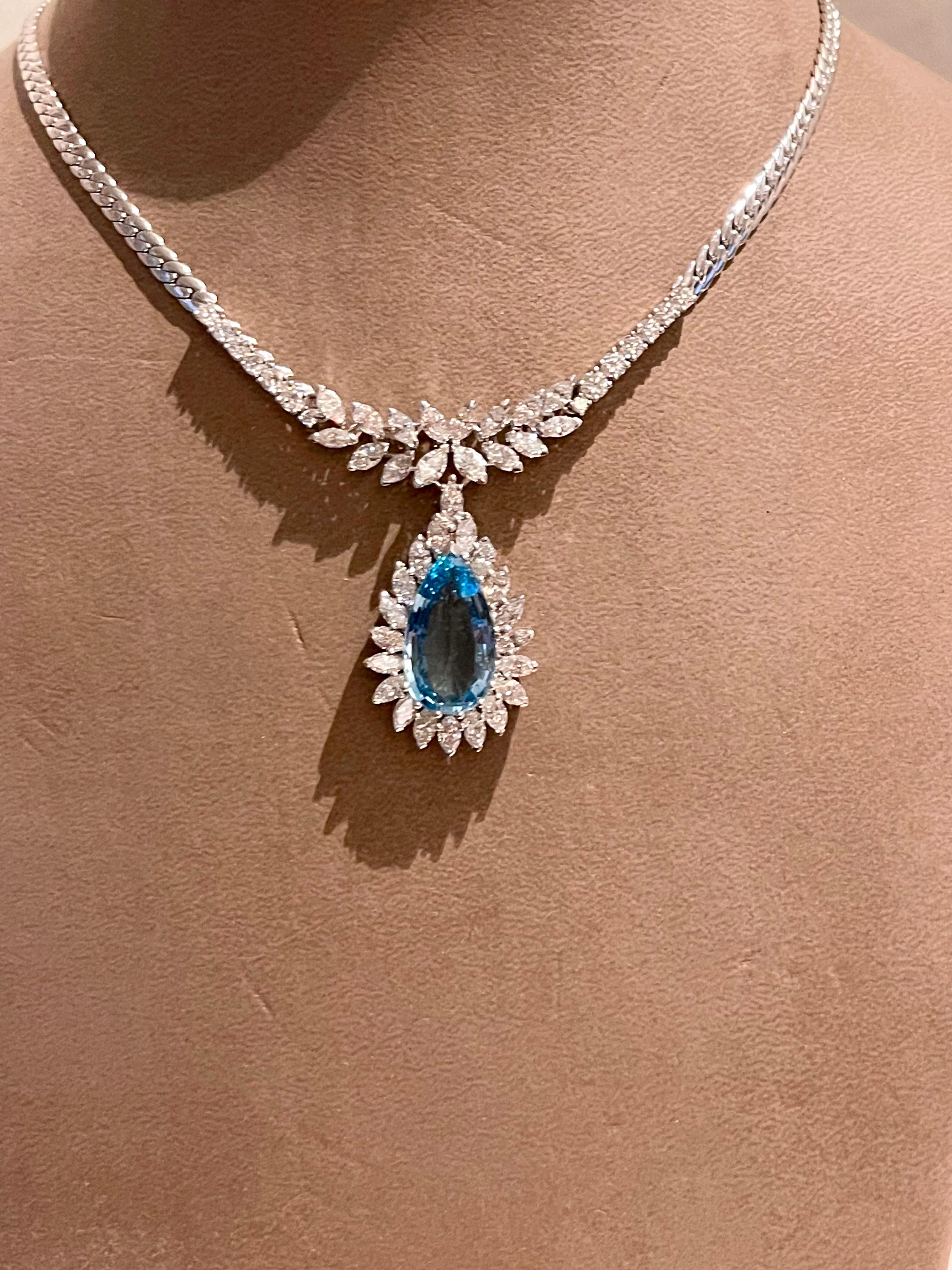 A very elegant and timeless 18 K white Gold necklace by Gubelin Lucerne, Switzerland featuring a very fine pear shape Aquamarine weighing approximtealy 5 ct, surrounded by 20 fine Marquise cut Diamonds. The necklace is set with 16 fine Marquise cut