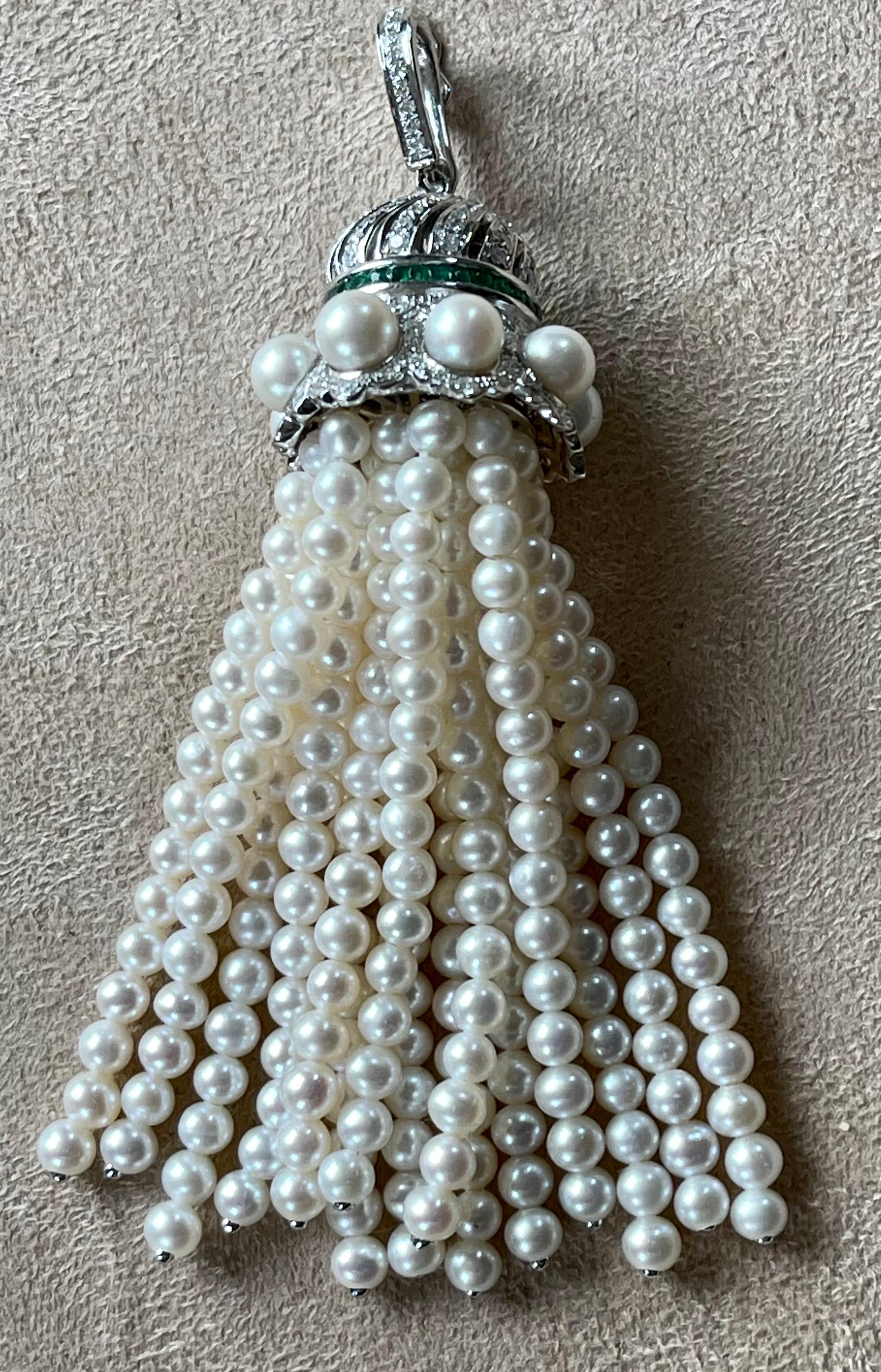 18 K white Gold tassel, featuring strands of graduating round cultured freshwater Pearls and brilliant cut Diamonds with a total weight of 0.80 ct and tiny Emeralds with a total weight of 0.30 ct. 
This elegant tassel pendant can be worn with any