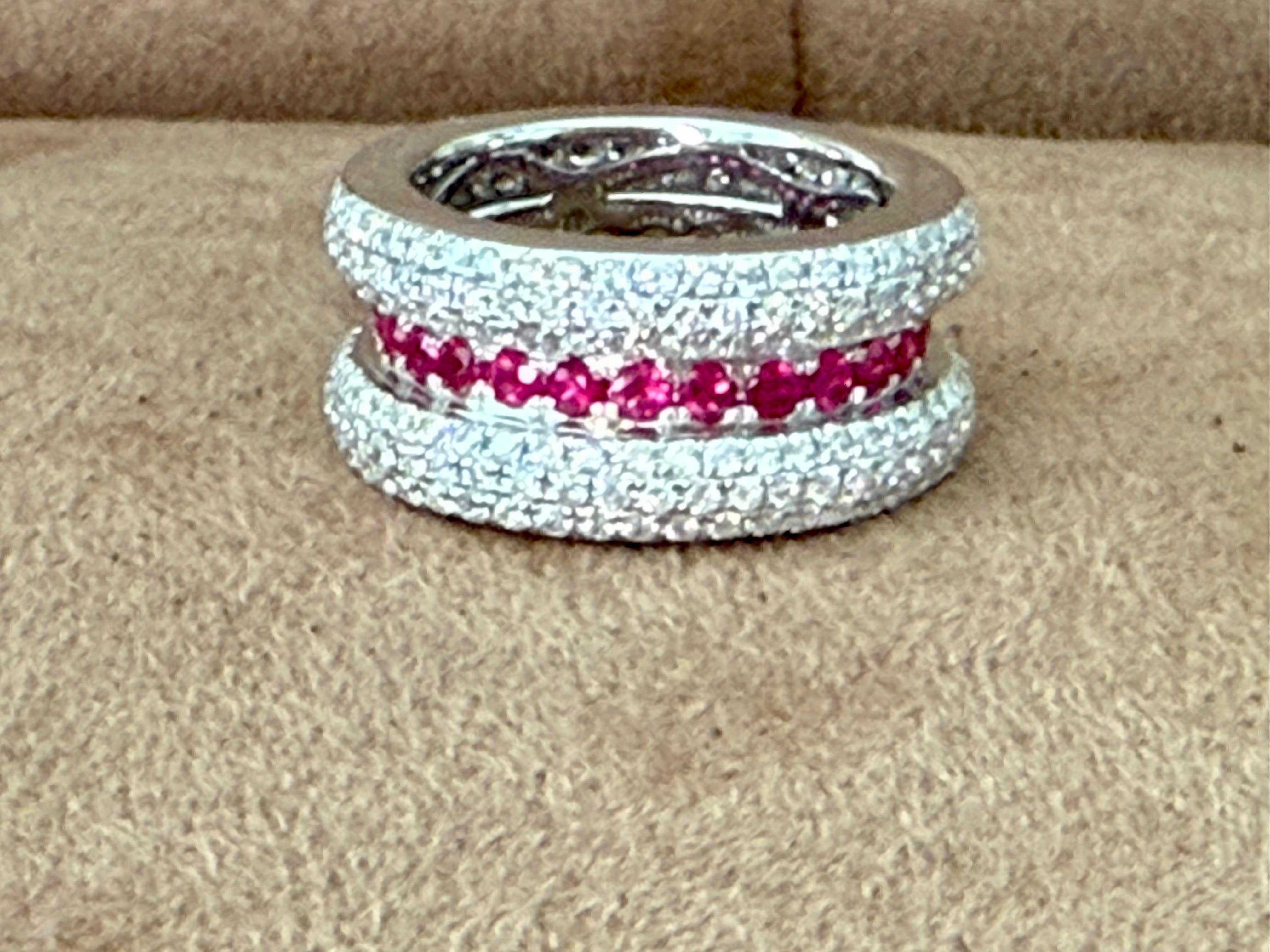 A sophisticated band ring crafted in 18 K white Gold, featuring 27 round Rubies weighing 1.40 ct and 288 round brilliant cut Diamonds weighing 2.60 ct, H color, si clarity in a refined pavé setting. 
The cool color of the white Gold with the intense