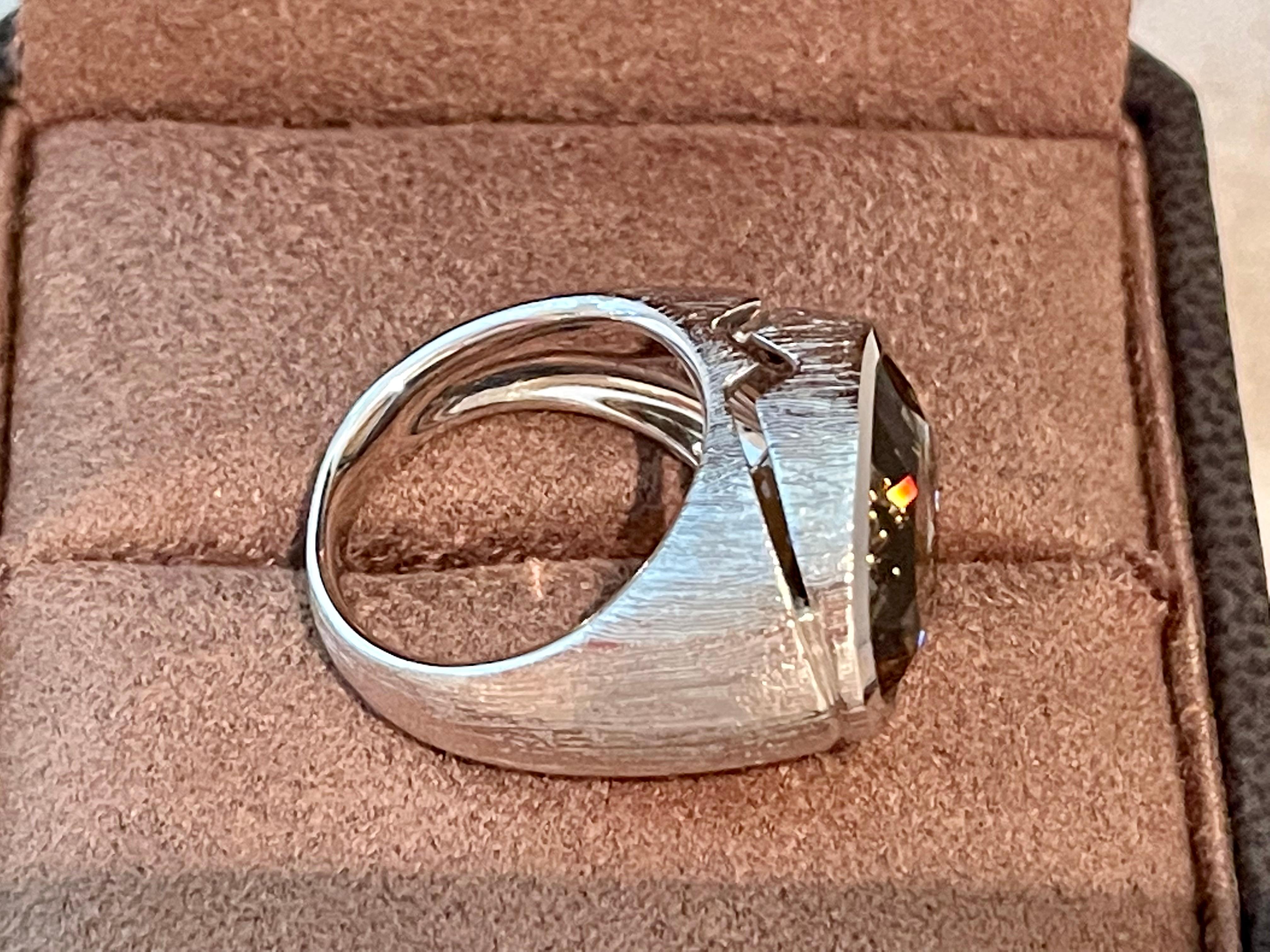 Dieser moderne Ring aus 18-karätigem Weißgold hat einen ovalen Rauchquarz mit einem Gewicht von 8,48 ct. in der Lünette. Das Gold hat eine gebürstete Textur. 
Der Ring hat derzeit die Größe 14/54 (amerikanische Ringgröße 7), kann aber leicht in der