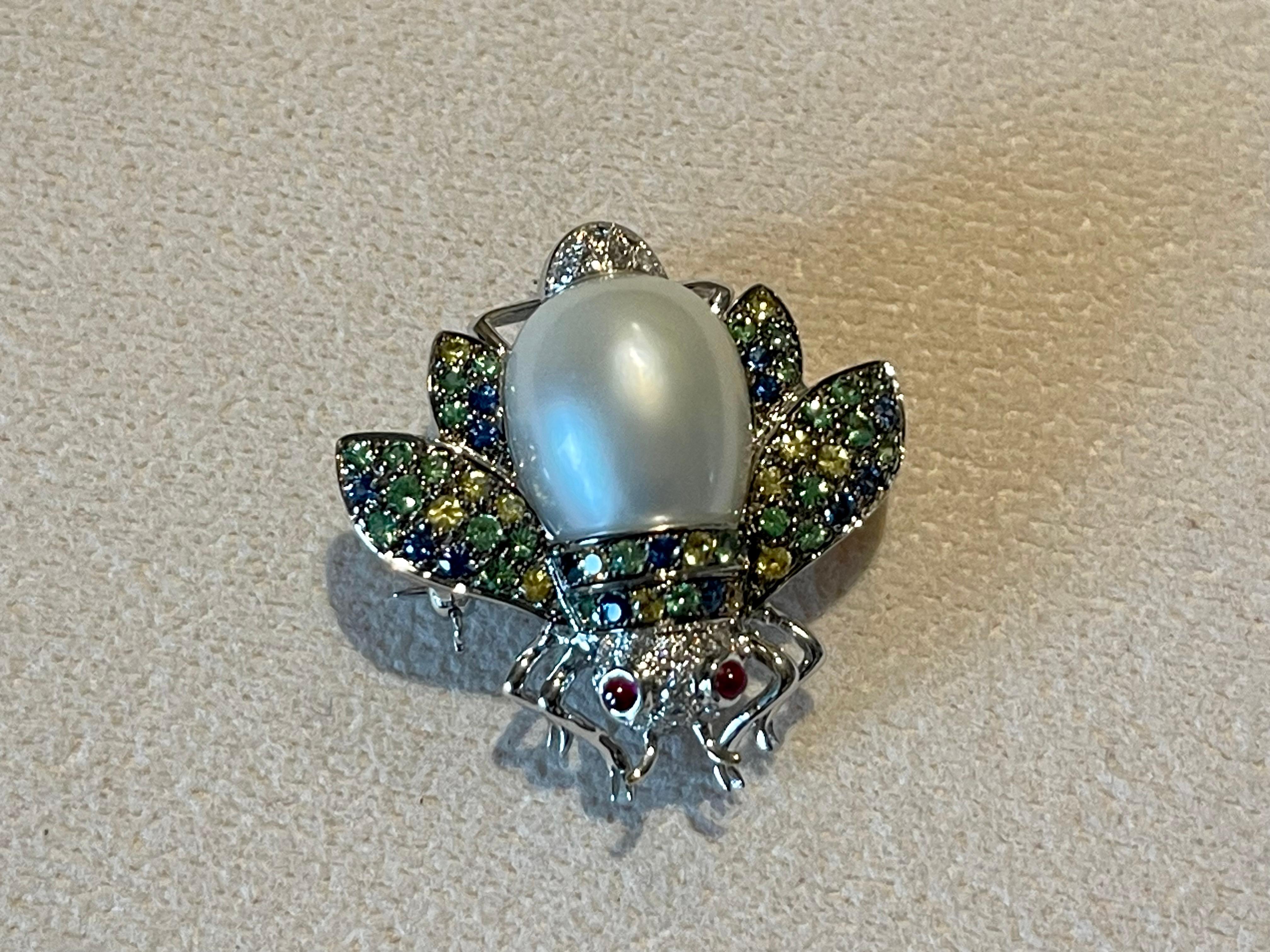 For all bee lovers- you are staring at a exquisite pin brooch!
Beautiful Bumble Bee brooch, set with 23 white brilliant cut Diamonds weighing 0.0.26 ct , G color, vs clarity, 2 Ruby cabochons eyes weighing 0.15 ct,  15 blue Sapphires weighing 0.41