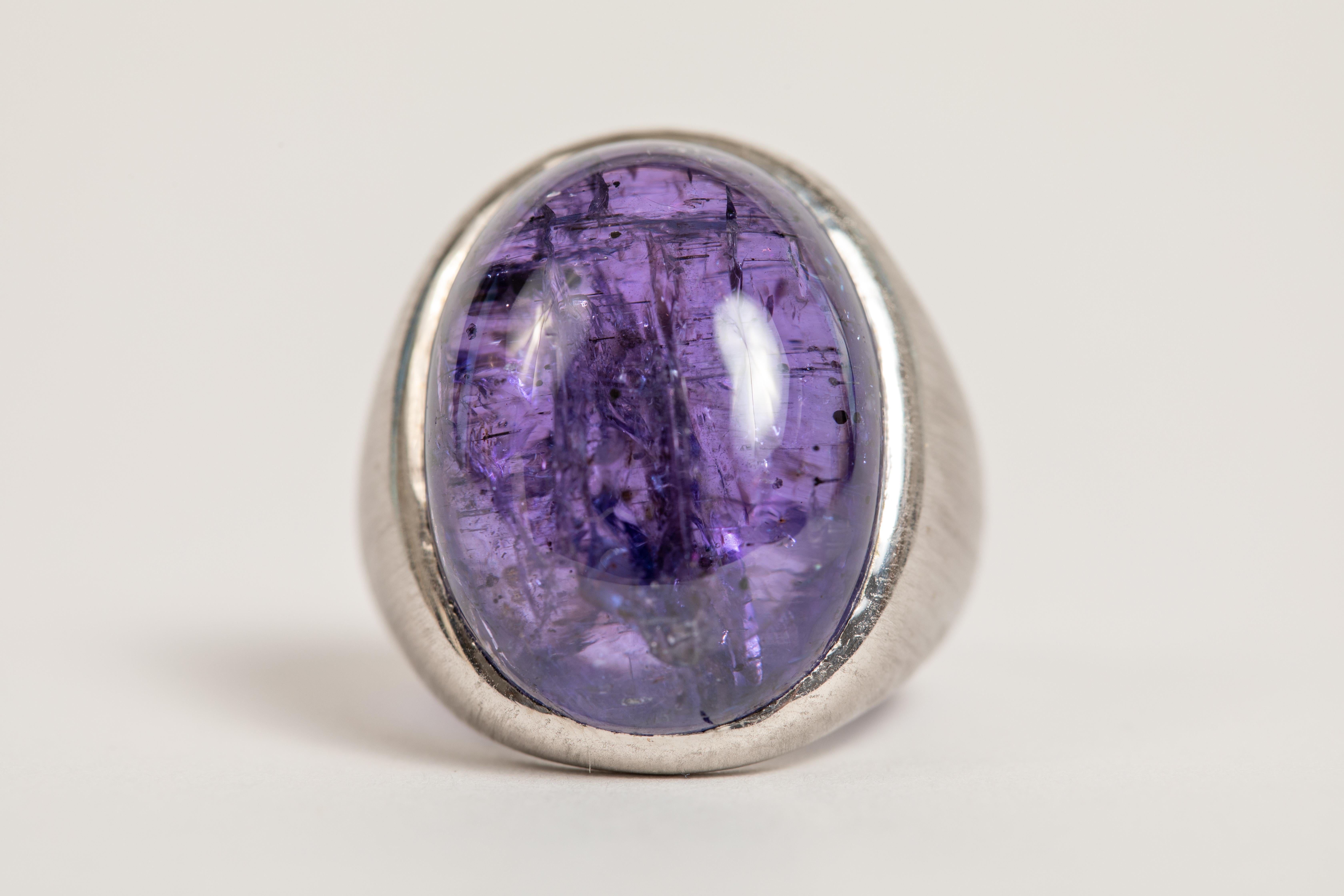 An intense blue/purple colour for this beautiful and voluminous ovale cabochon on a 18K white brushed gold ring. 
Created by Marion Jeantet
Finger size  55 or 7 1/4, can be adjusted
Total weight 21.70 g
Unique Tanzanite cabochon weight: 36.97