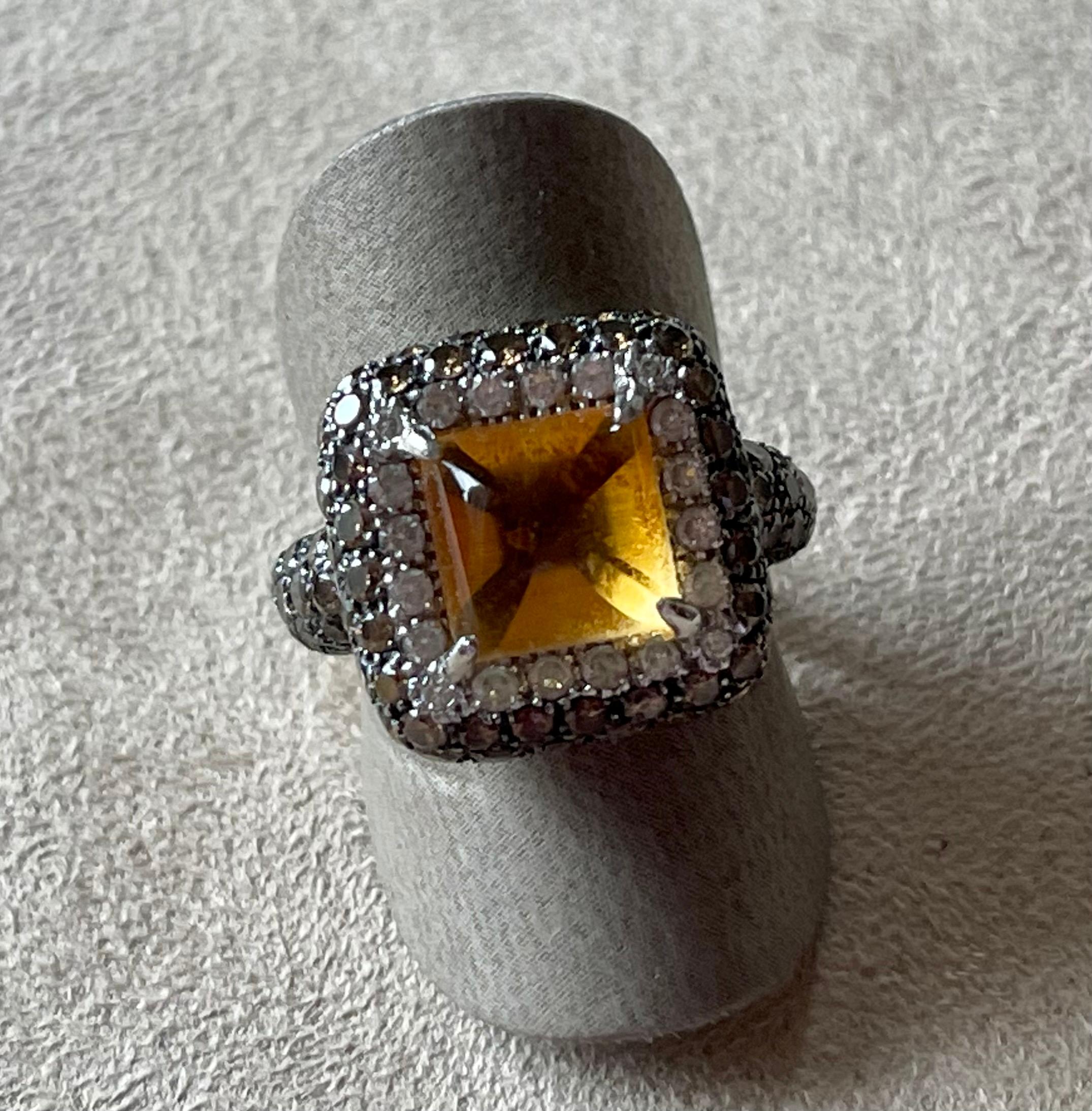 Attractive 18 K white Gold Cocktail Ring featuring a sugarloaf Citrine Cabochons weighing 3.49 ct surrounded by 20 white brilliant cut Diamonds weighing 0.40 ct and 86 Champagne colored brilliant cut Diamonds with a total weight of 2.21