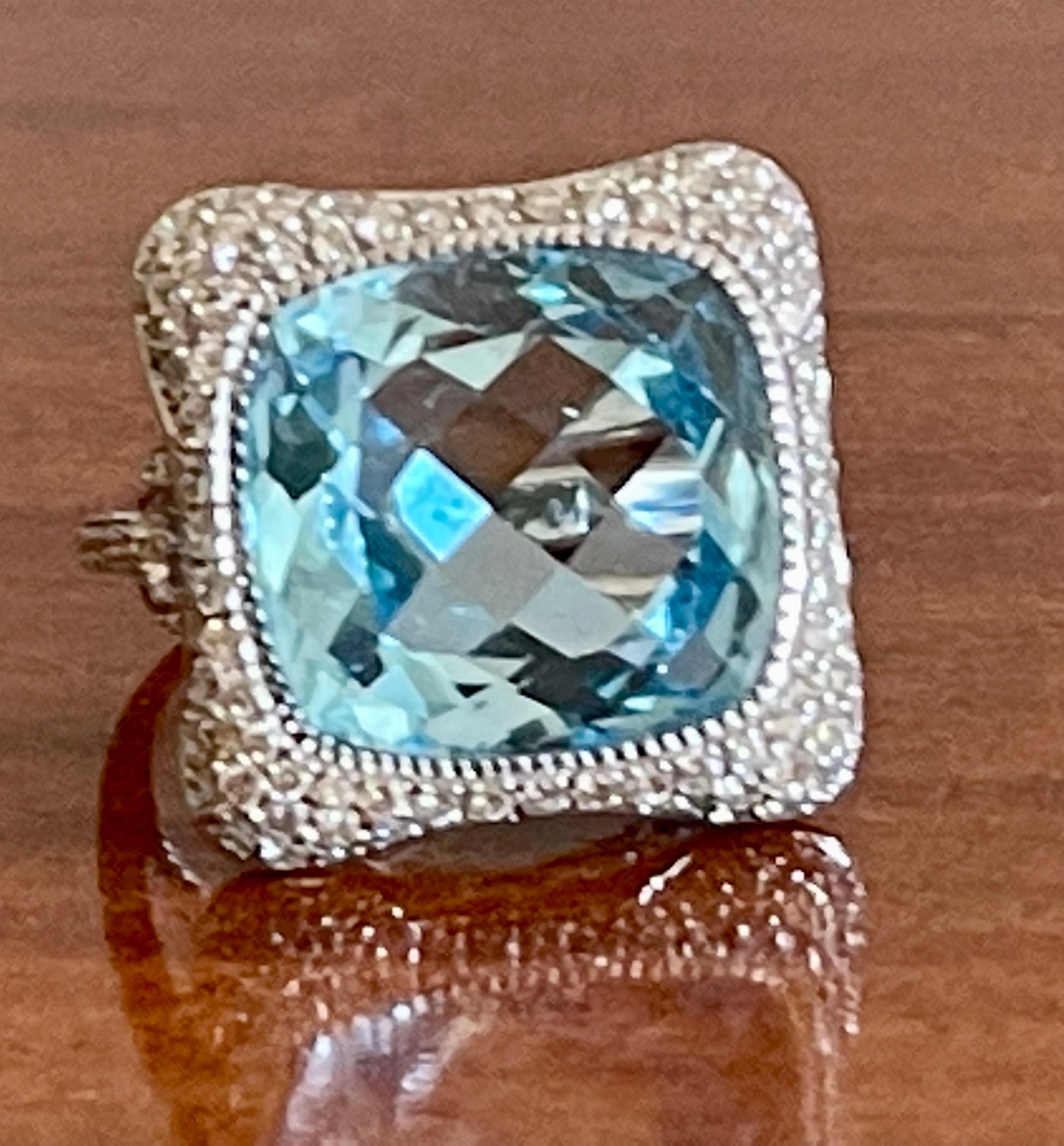 Exquisite cocktail ring crafted in 18 karat white gold showcasing a spectacular fantasy cushion cut sky blue Topaz weighing 16.88 carats. The Topaz is framed with 115 brilliant cut Diamonds weighing 1.04 ct, G color, vs clarity. The face of this