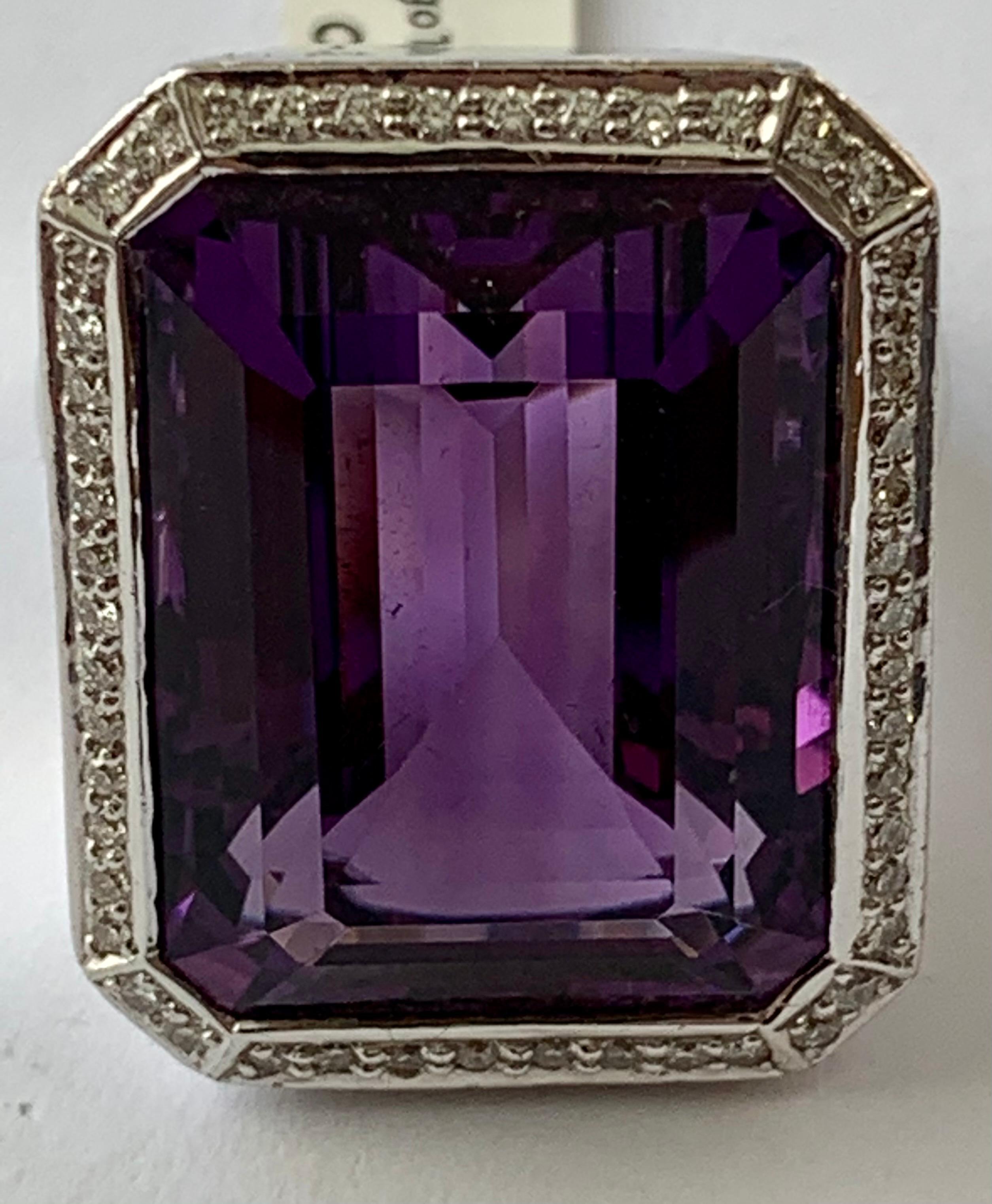 A real eye catcher this 18 K white Gold Cocktail ring. The amethyst is surrounded by small diamonds! 
Dimension of the Amethyst 2.6 cm x 2.0 cm. Very solid ring!
The ring is currently size 57 but can easily be resized!
Authenticity and money back is
