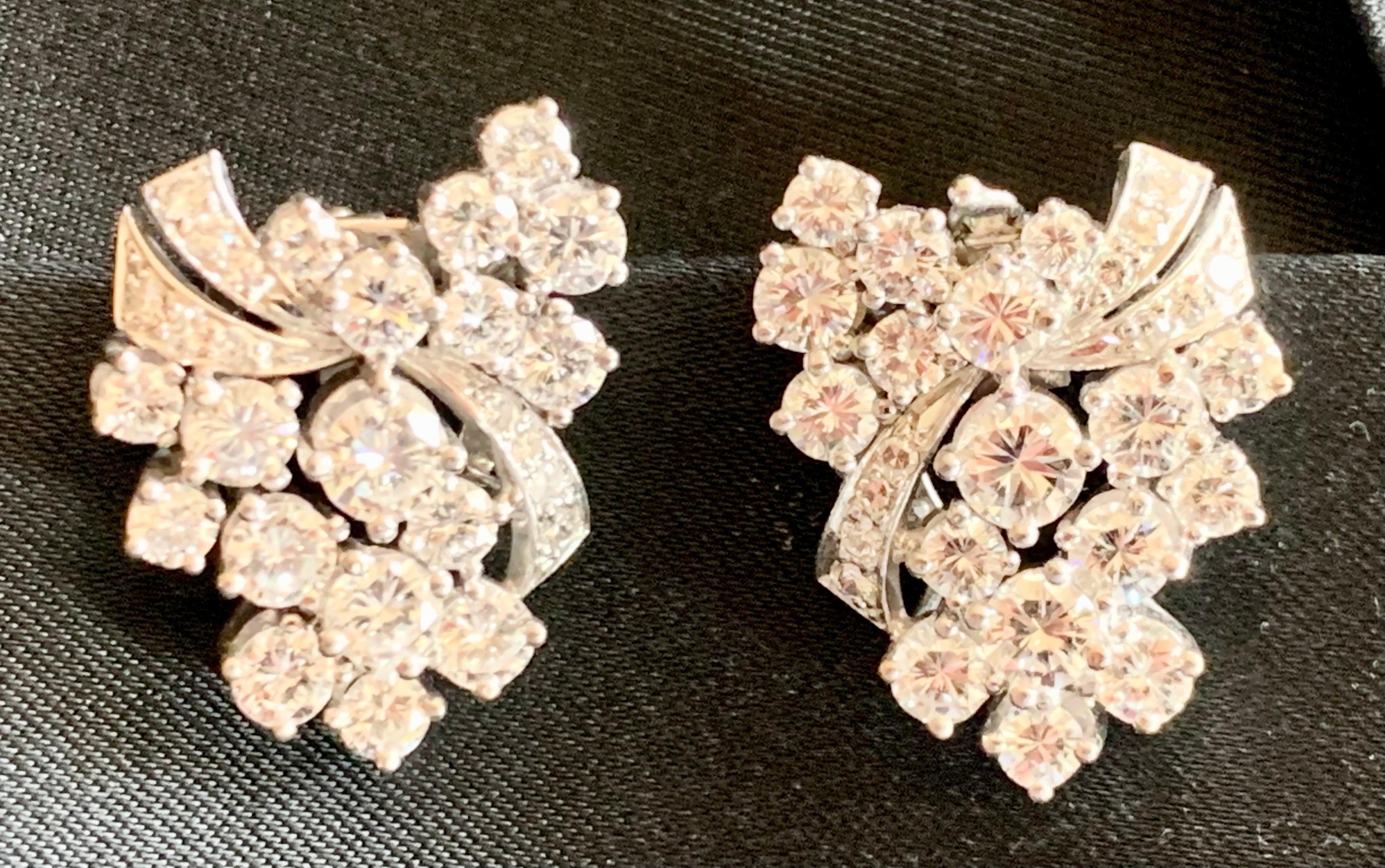 A pair of timeless and classy 18 K white Gold cluster earclips set with 54 brilliant cut Diamonds weighing approximately 4.20 ct, G color , vs clarity. 
These earrings were impeccably designed to cover the ear lobe and climb the ear.  
Masterfully