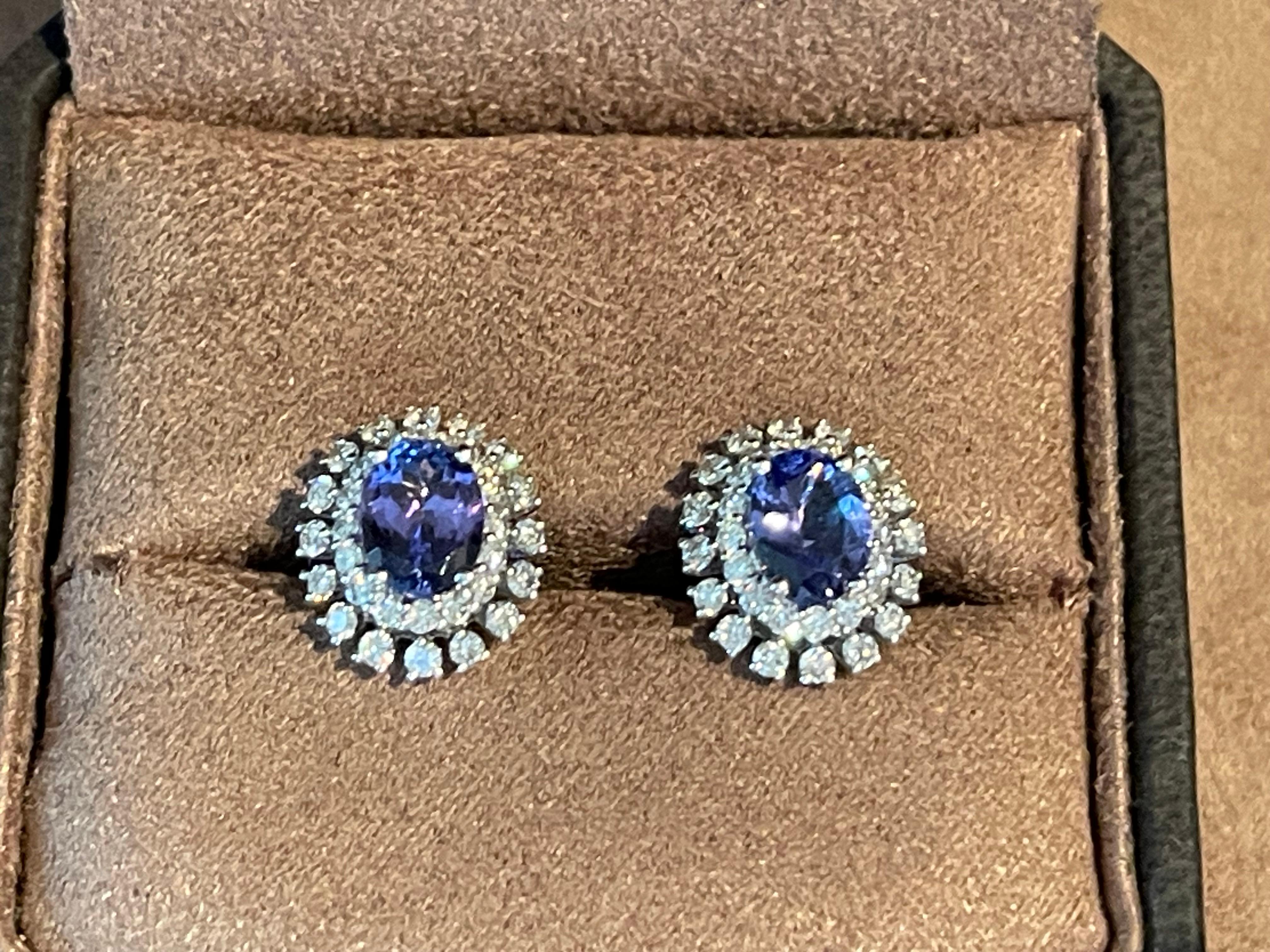 Gorgeous 18 K white Gold earrings featuring 2 oval Tanzanites weighing 2.69 ct in a double halo design, set with 64 brilliant cut Diamonds weighing 1.19 ct. Earrings have post backs, with 18 K white Gold butterfly clasps. These lovely earstuds will