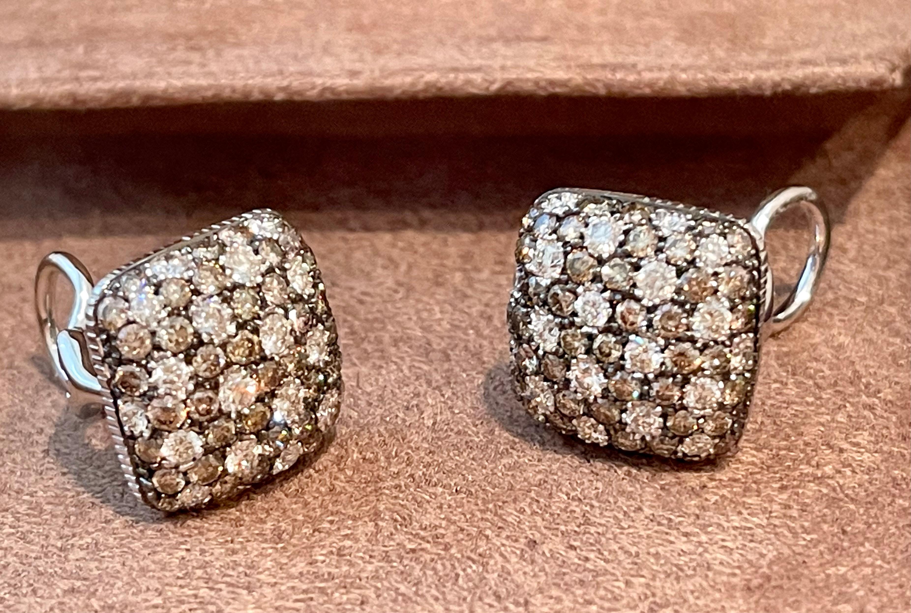 Very elegant and timeless cushion shape bombé style 18 K white Gold earclips featuring white and Champage colored Diamonds. 1.62 cm x 1.62 cm. 
Masterfully handcrafted piece! Authenticity and money back is guaranteed.
For any enquires, please