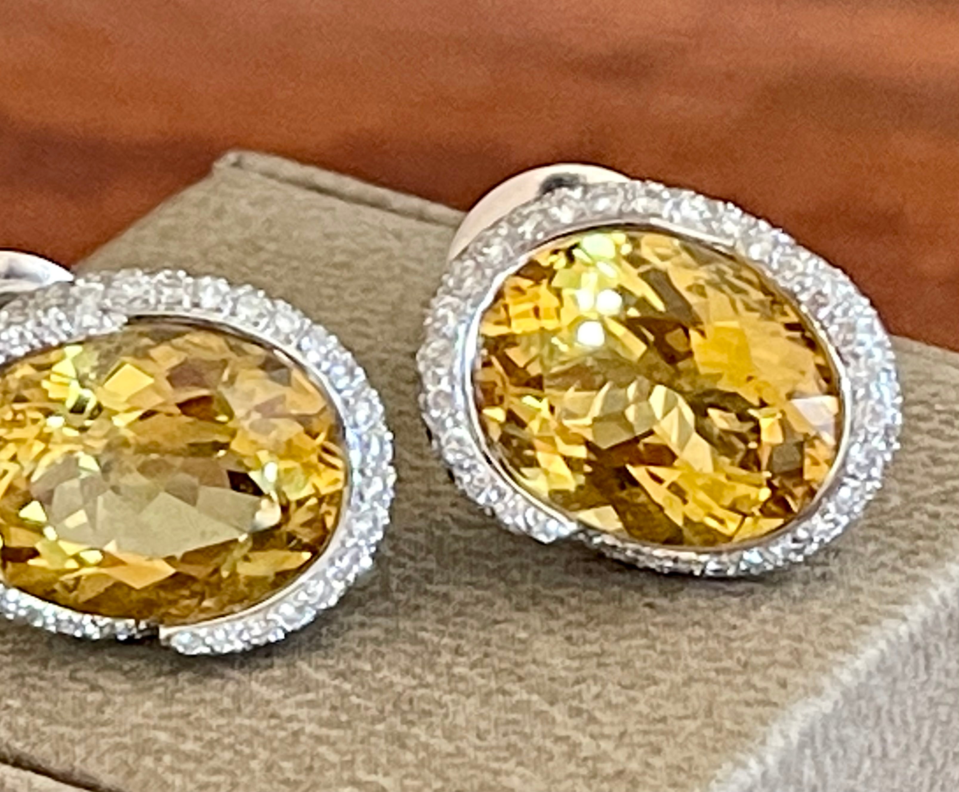 This fabulous earstuds in 18 K white Gold feature 2 vivid yellow oval Beryls weighing 9.96 ct in a modern pave set Diamonds surround of circa 1.80  ct. It is signed Gübelin Lucerne, Switzerland. Matching Ring available. Posts with a heavy push backs