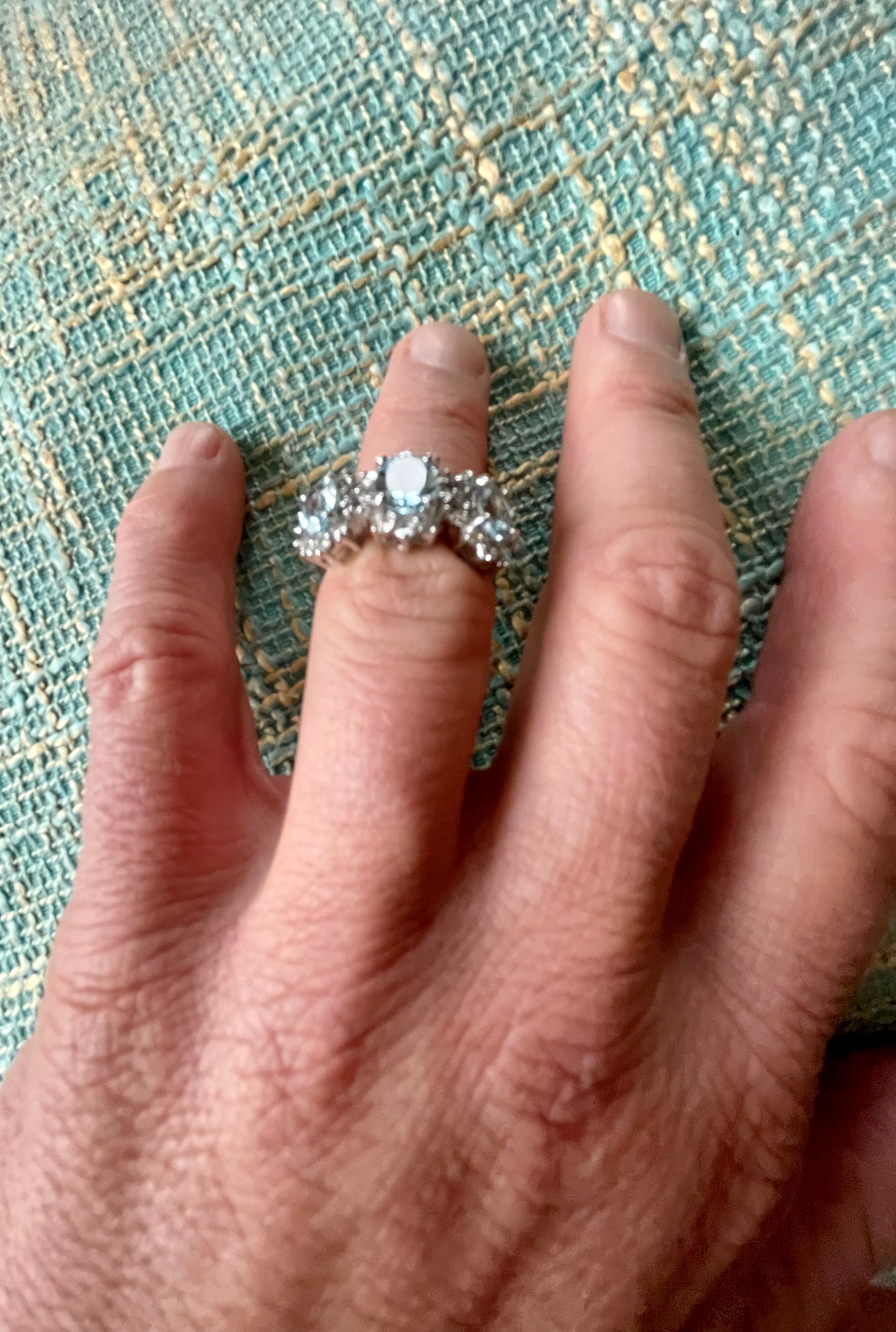 Lovely 18 K white Gold Ring featuring 3 lovely oval light blue Aquamarines weighing 2.47 ct. Each of the 3 Aquamarines is surrounded by Diamonds. Total weight of the brilliant cut Diamonds ca 1 ct. 
The ring is currently size 14/54 ( American Ring