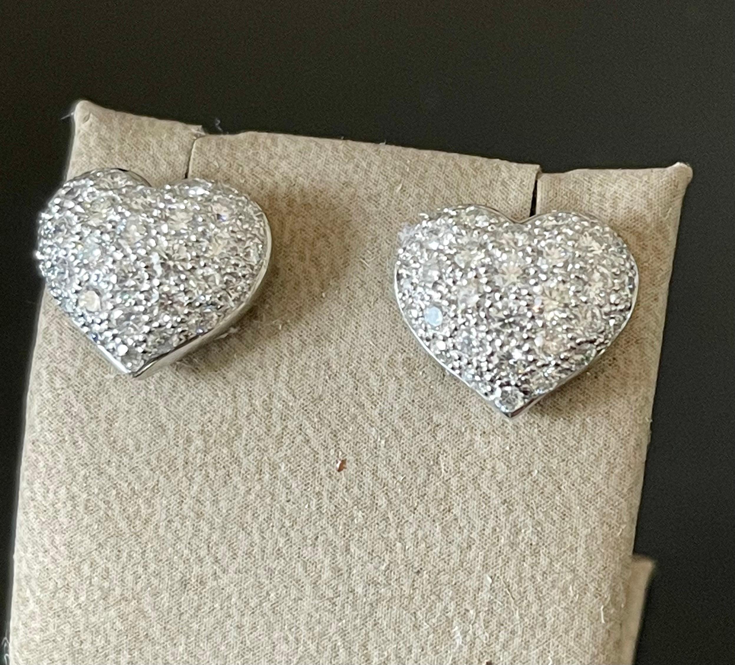 These stunning 18 K white Gold heart shaped pave diamond stud earrings provide a look that is both trendy and classic. These diamond earrings are a great staple to add to your collection, and can be worn with both casual and formal wear. These