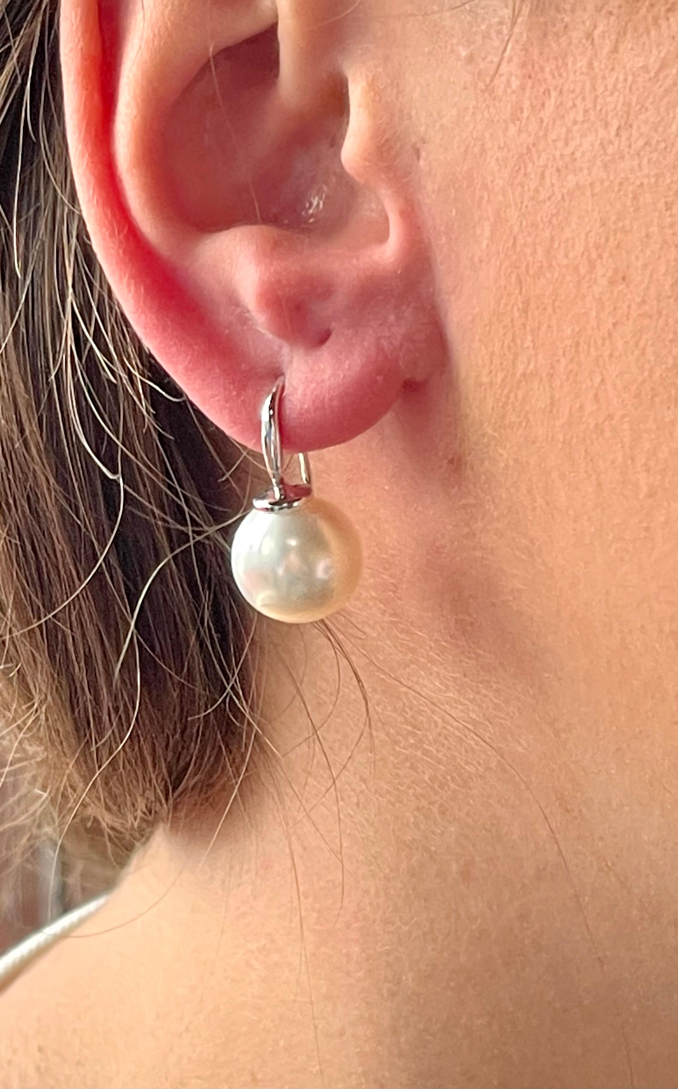Pure simplicity these lovely 18 K whitel gold drop South Sea Pearls earrings. The pearls measure 13 mm in diameter and have a nice lustre. Also available in 18 K rose Gold. 
Masterfully handcrafted piece! Authenticity and money back is guaranteed.