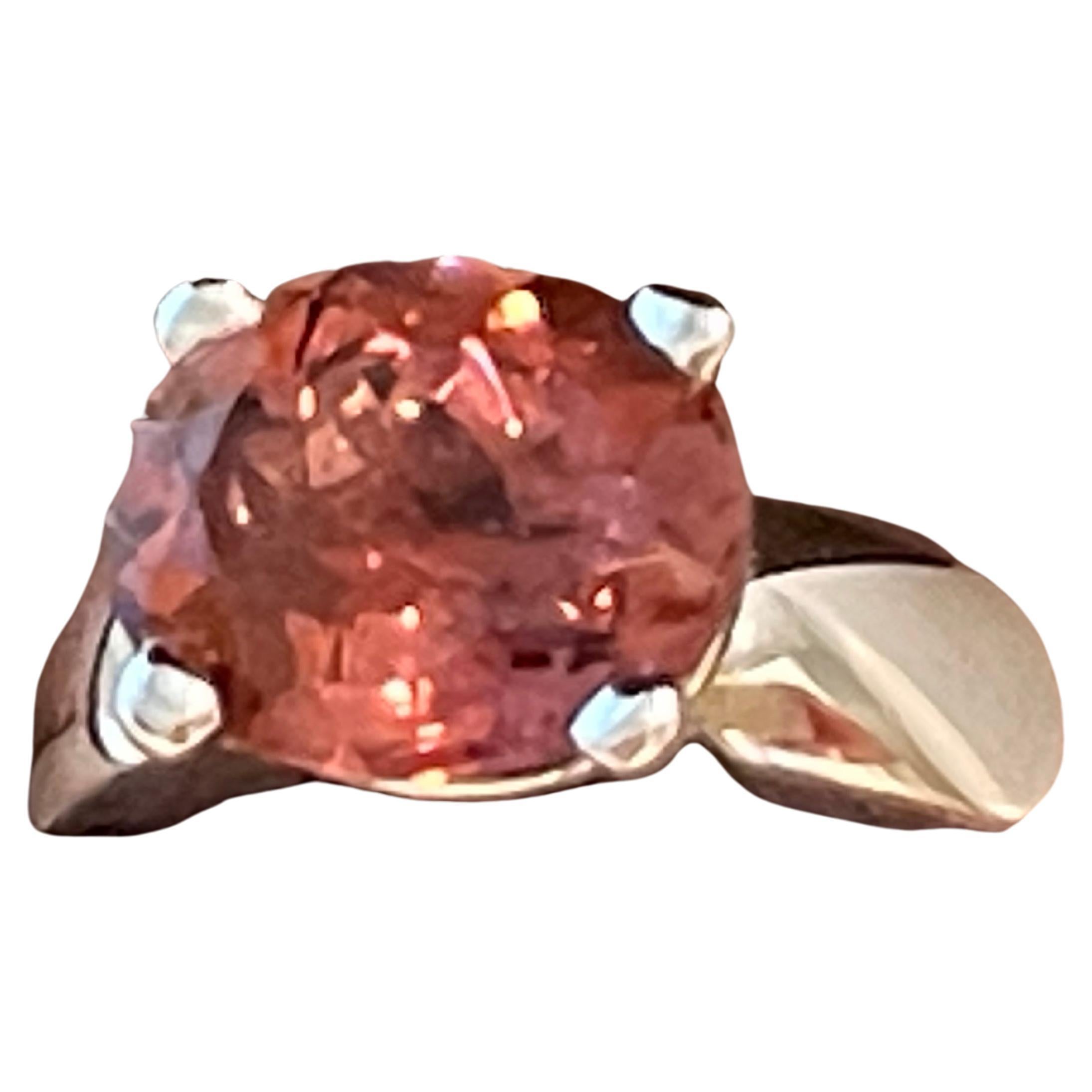 This solid elegant and timeless ring is crafted in 18 K whitel Gold and features a lovely oval pink Tourmaline weighing 5.13 ct. Signed Gübelin Lucerne Switzererland. 
The ring is currently size 15/55( american ring size 7 1/2) but can easily be