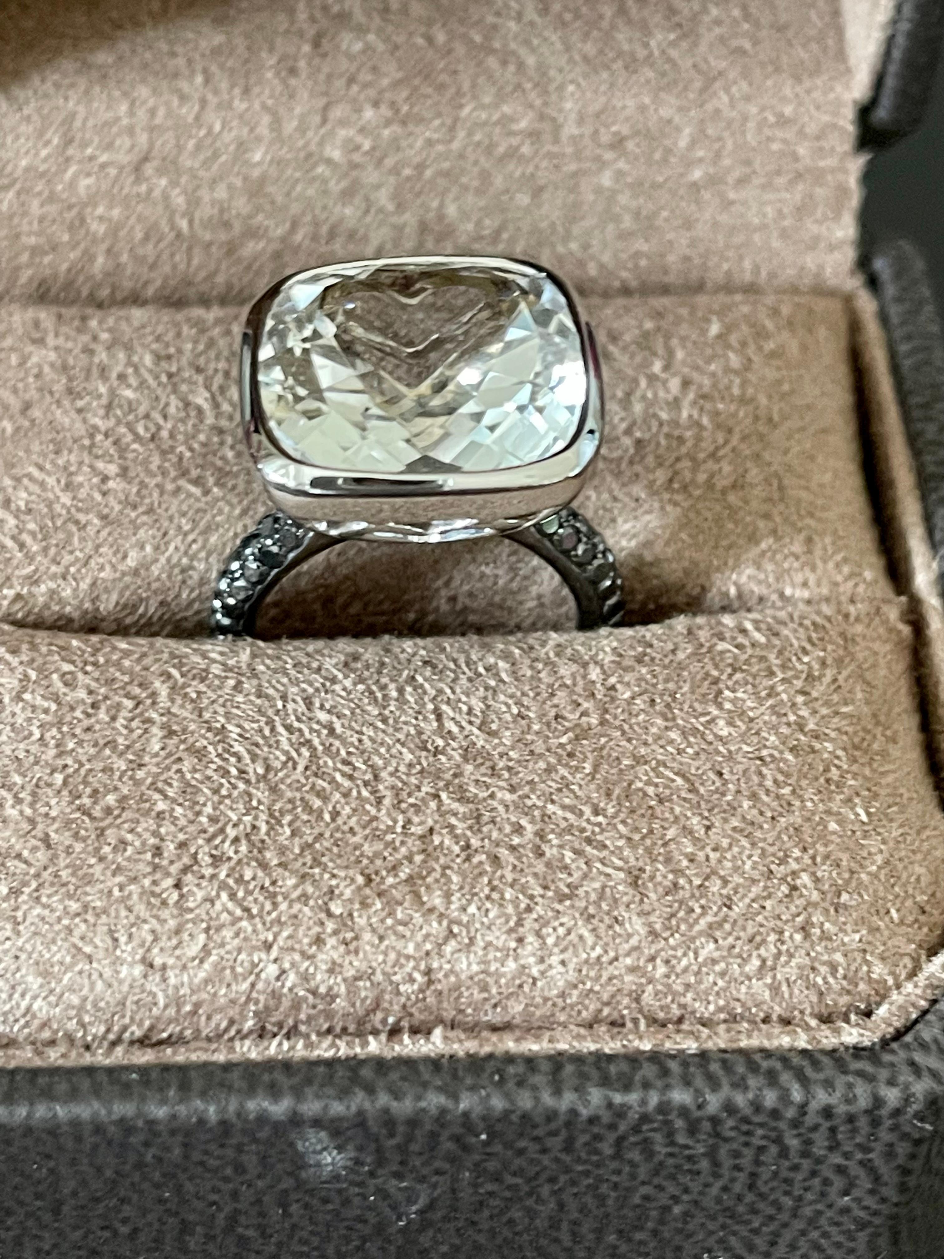 A real eye catcher this statement ring. The white cushion  cut Topaz looks like a Diamond. The white Topaz has the impressive weight of 13.53 ct  and the shoulders are set with 50 black brilliant cut black Diamonds weighing 0.68 ct. 
The ring is