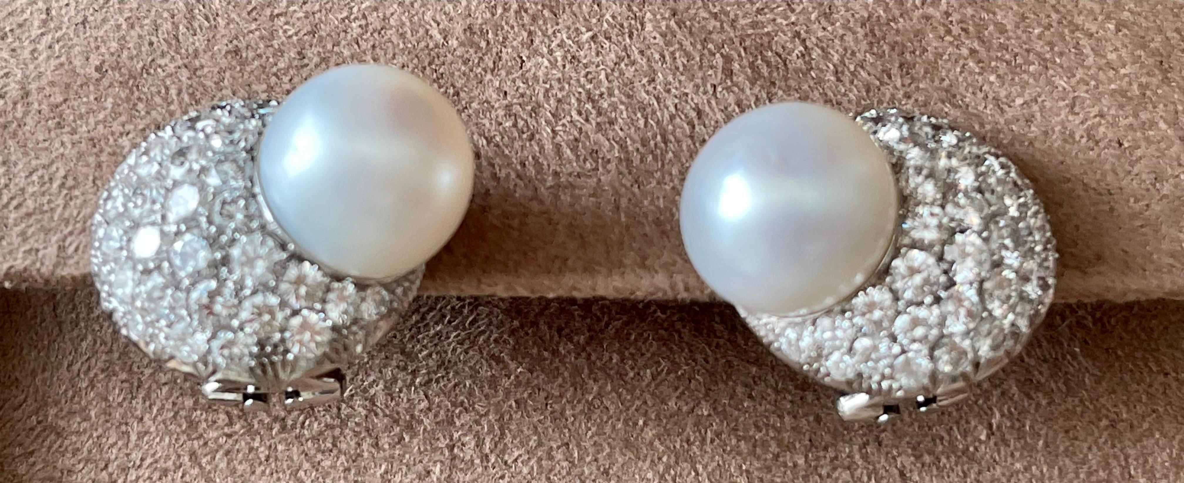 Stunning diamond and South Sea pearl earrings fashioned in 18 K white Gold. The 11 mm South Sea pearls are surrounded by 81 pave set brilliant cut Diamonds. The diamonds weigh approximately 3.30 carat total weight and are graded F-G color and VS