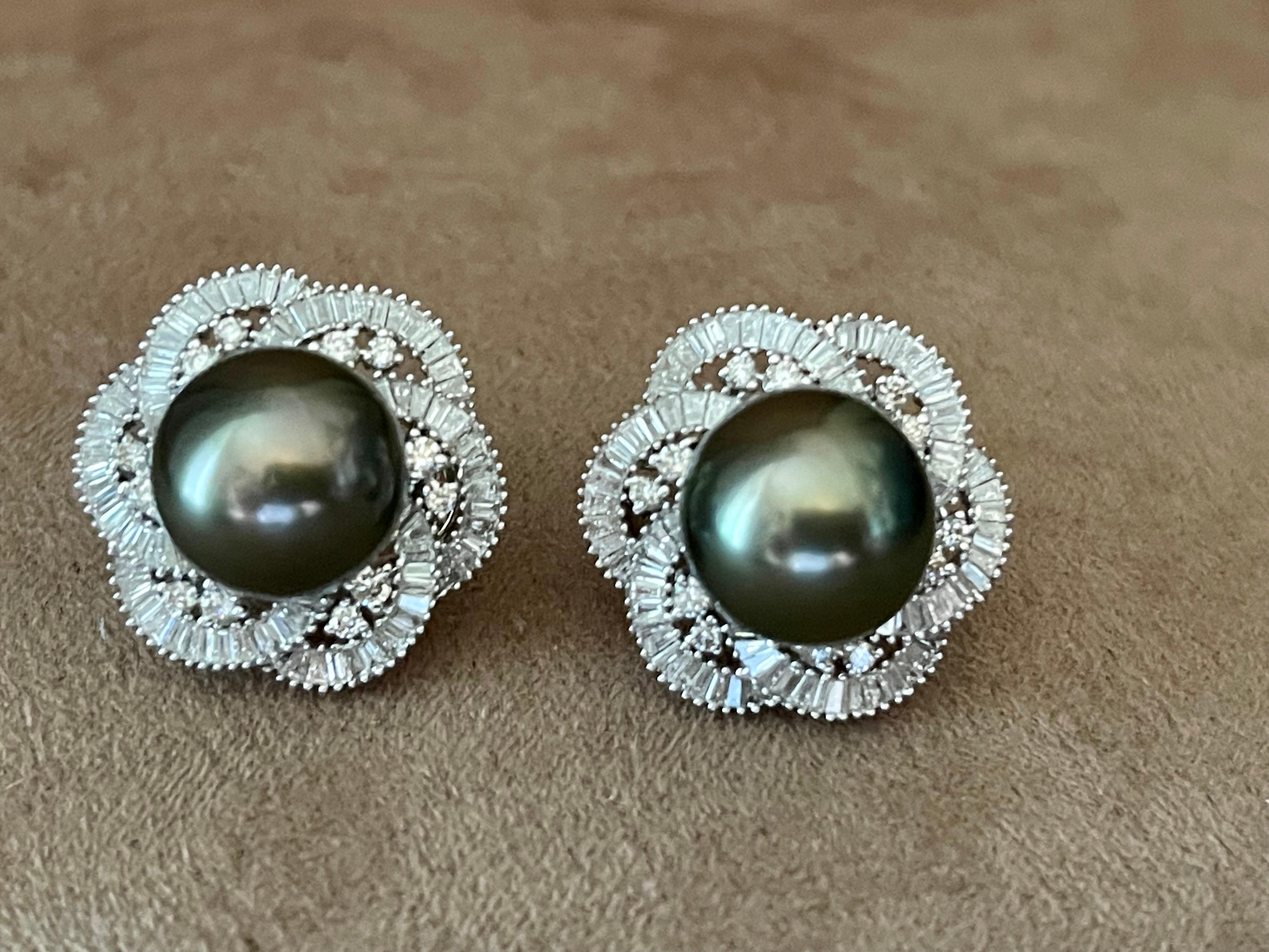 A pair of timeless 18 K white Gold earrings featuring 2 Tahitian pearls measuring ca. 12mm surroundes with a halo design that consists of 24 brilliant cut Diamonds weighing 0.55 ct and 167 tapered Baguette Diamonds weighing 1.25 ct. These stunningly