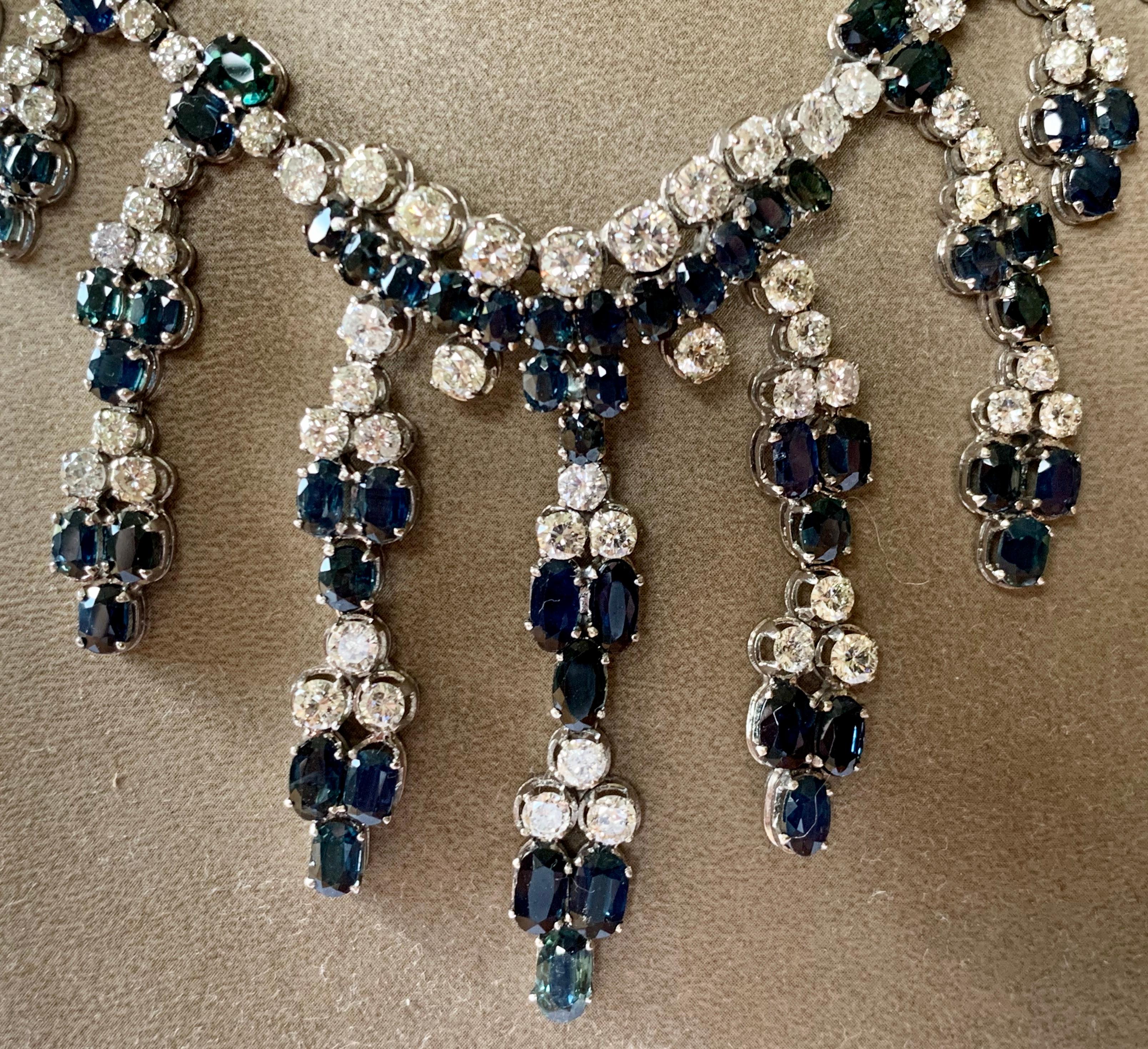 An eye catching and brilliant necklace showcasing 147 brillant cut Diamonds weighing approximately 19.0 ct, J color, si clarity and 131 blue Sapphires totaling ca. 21.0 ct., set in an intricate and fringe design. Made in 18 karat white gold.  