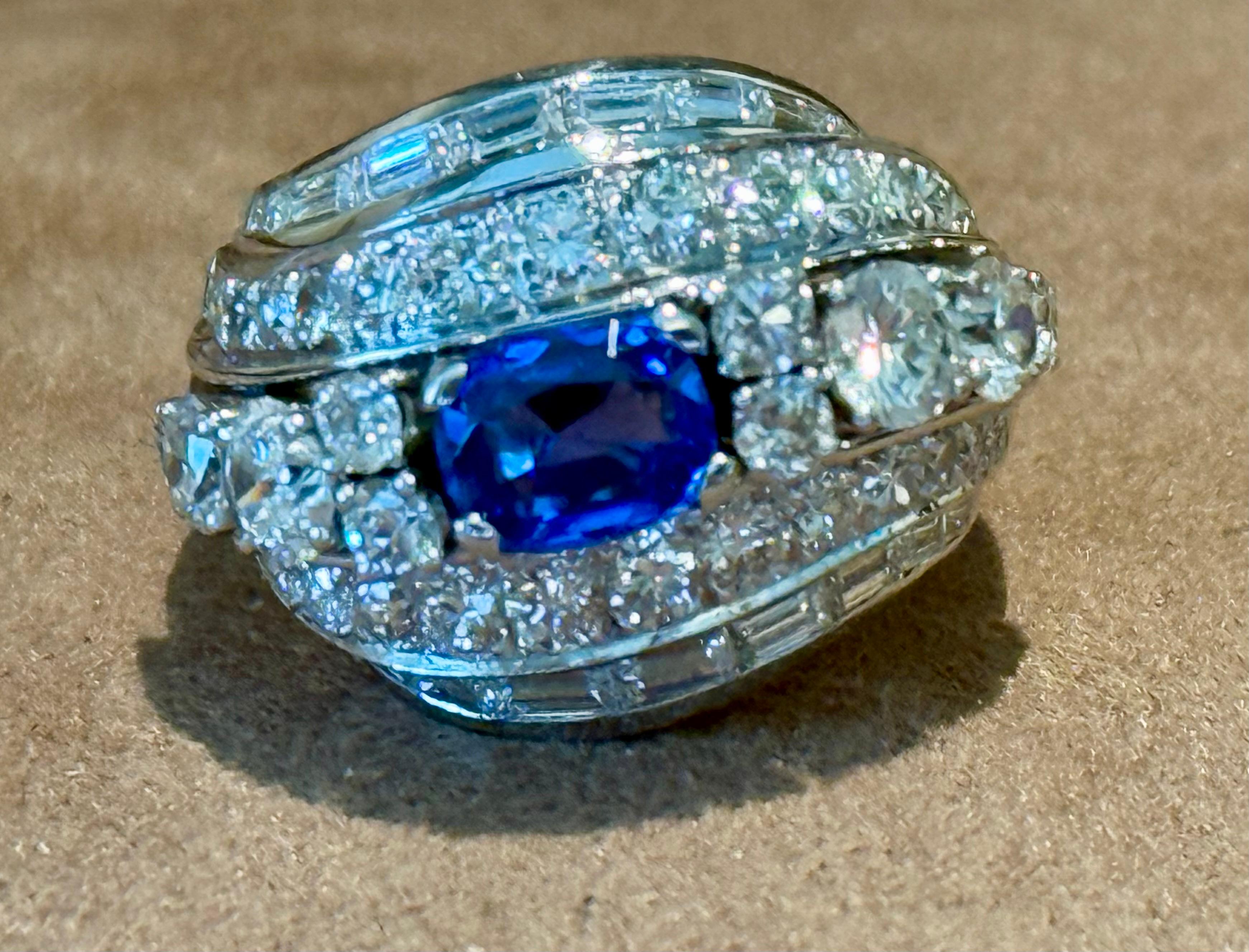 This wonderful Vintage 18 K white Gold Cocktail ring features a natural royal blue oval sapphire weighing ca. 1.02ct in a four claw, open back setting. The vibrant stone is beautifully surrounded and adorned by 44 brilliant cut Diamonds weighing ca.