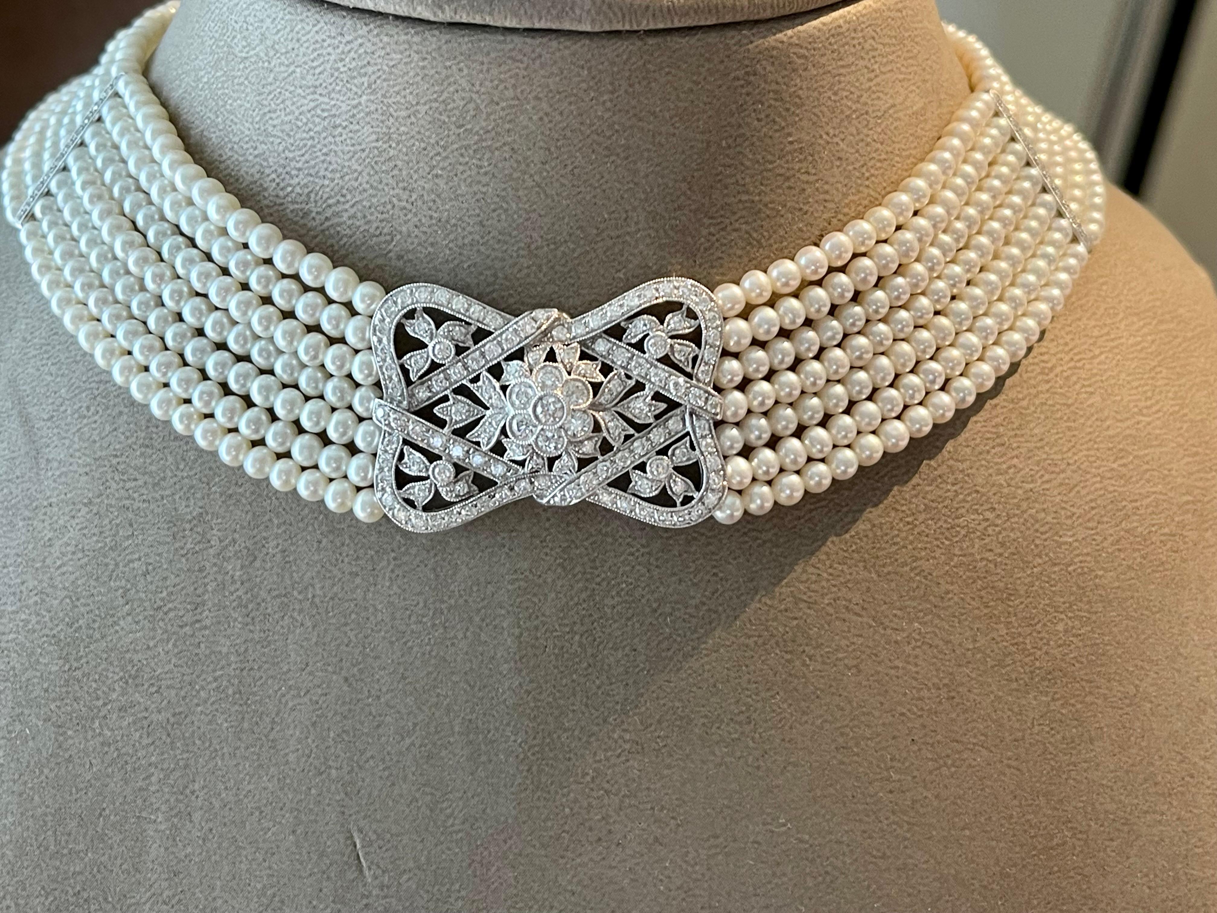 Pearl Diamond 18 K white Gold Collar Choker Necklace. It is formed of 7 rows of lustrous white 3.5 mm cultured pearls strung to diamond set bars and a highly decorative diamond  Belle Epoque style centrepiece with elaborate detailing. The total