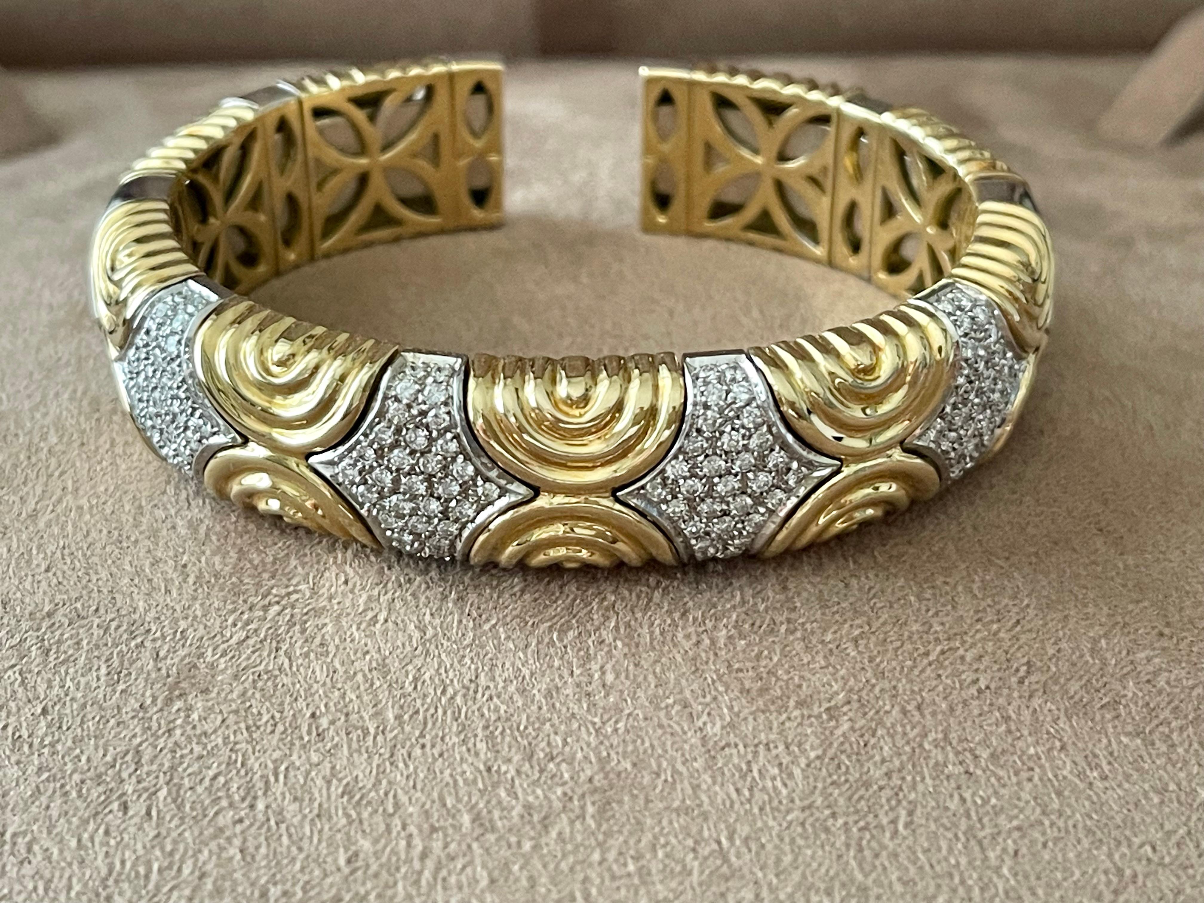 A timeless and very elegant italian 18 K yellow and white Gold Bangle bracelet pave set with brilliant cut Diamonds weighing approximately 2.00 ct. An iconic italian made cuff bracelet composed of sculptued geometric links. The bangle is flexible