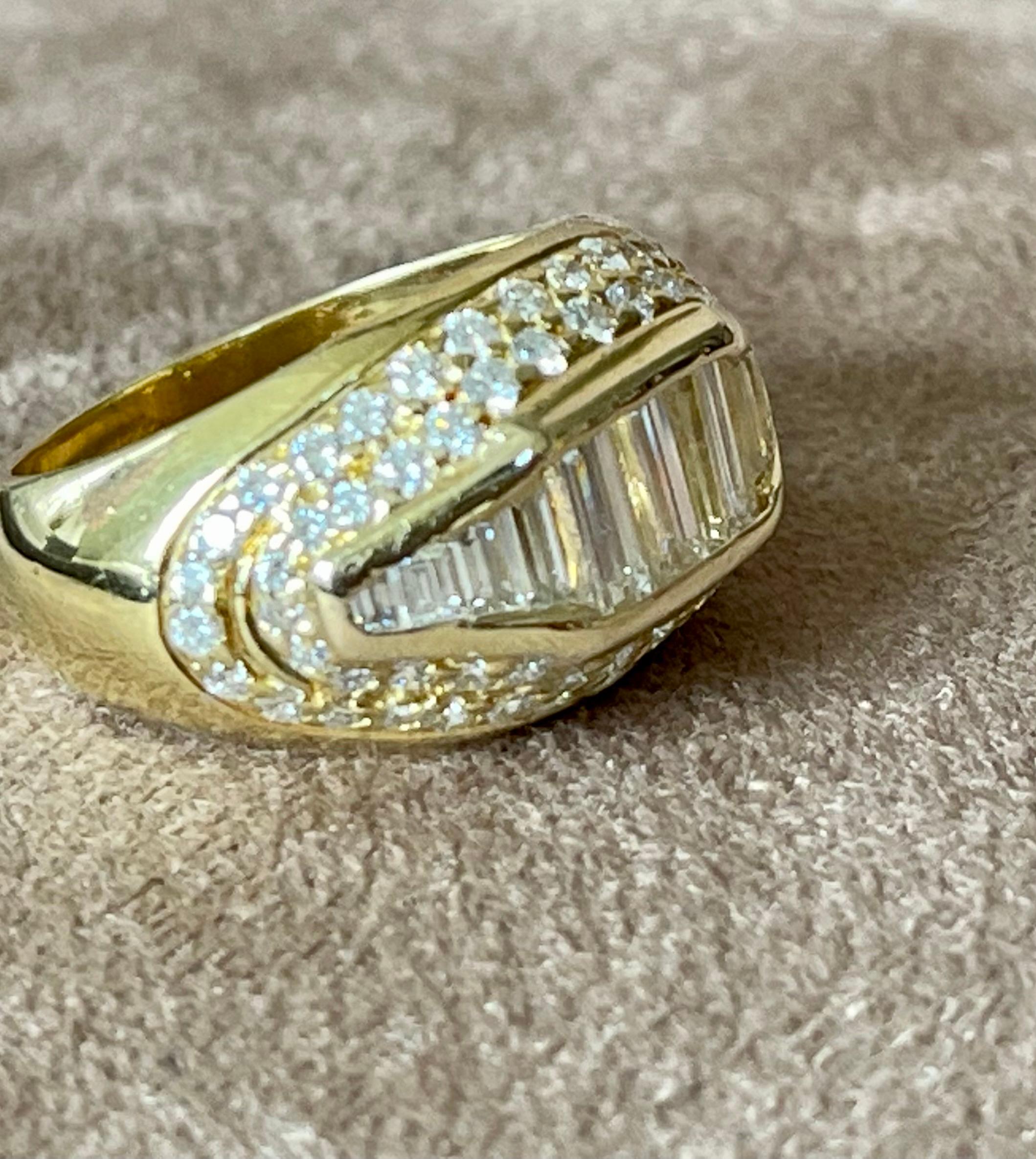 Beautiful diamond  band fashioned in 18 K yellow Gold. The band features 11 baguette shape diamonds weighing approximately 1.20 carat total weight, and round brilliant cut diamonds weighing approximately 0.90 ct. The diamonds are graded H-I color