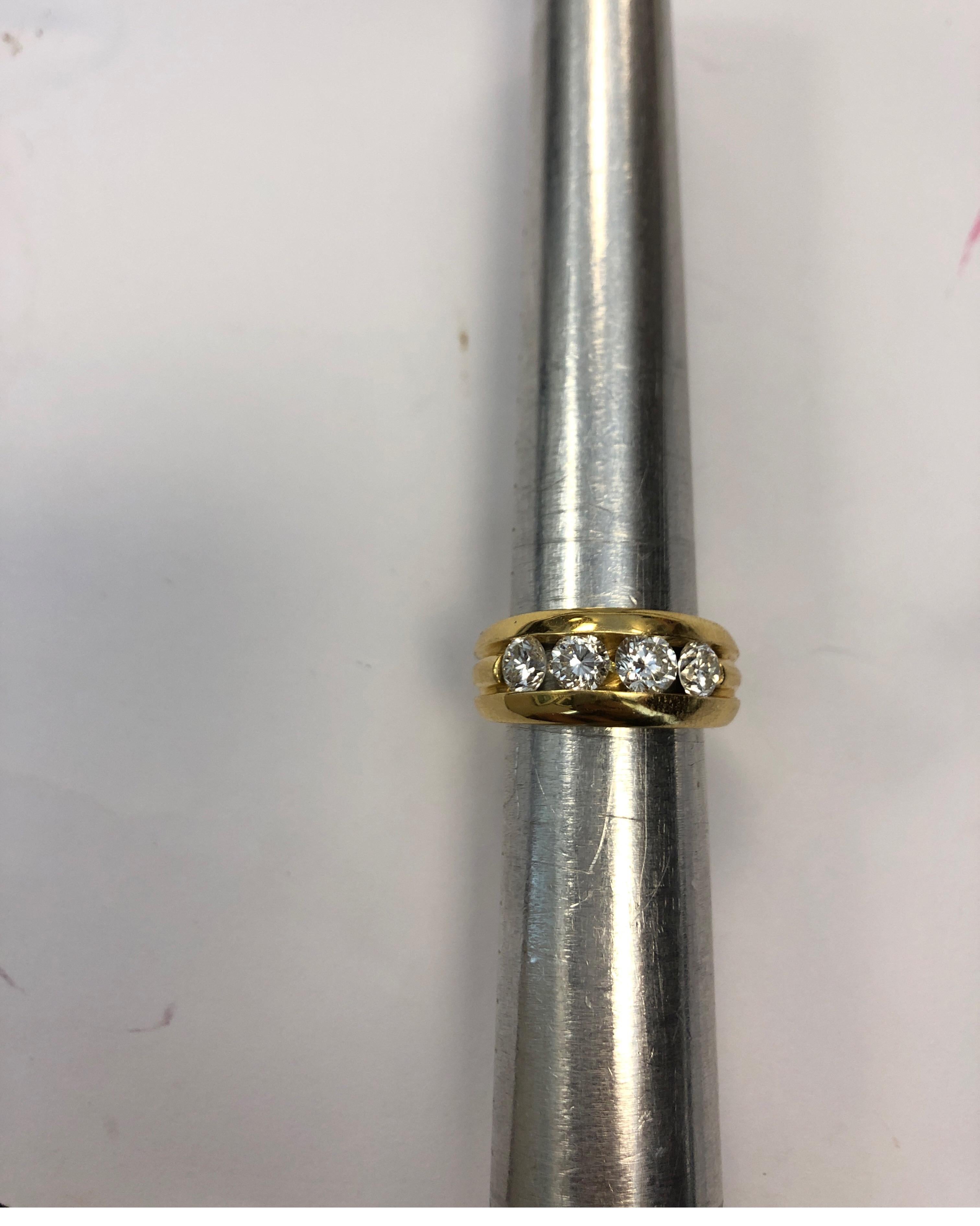 Contemporary 18 Karat Yellow Gold Band Ring Channel Set with Four Round Diamonds For Sale