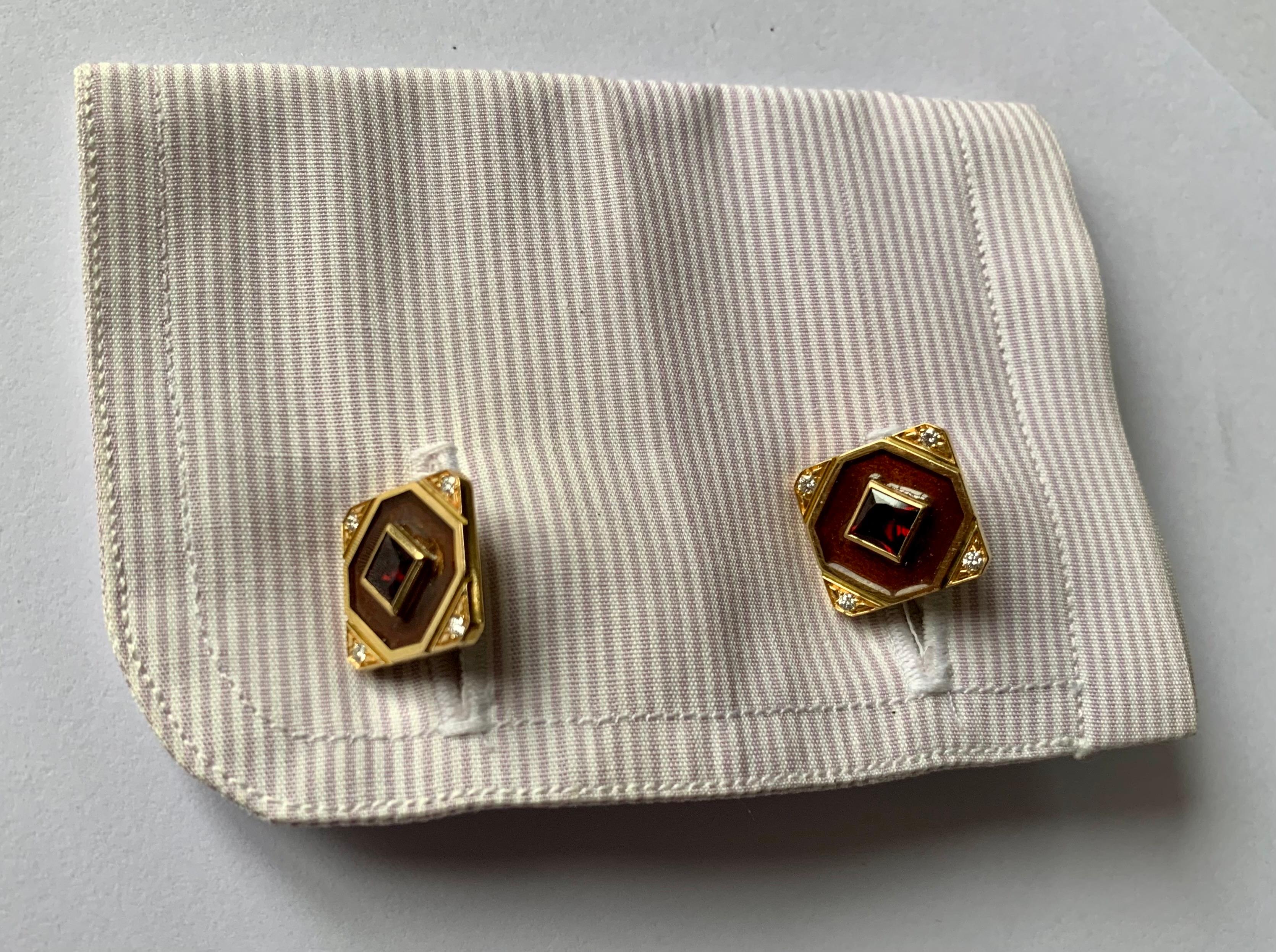 A pair of unusual hand made 18 K yellow Gold cufflinks featuring 2 Garnets weighing 1.72ct  and 8 brilliant cut Diamonds weighing 0.16 ct. Brown enamel to create this harmonious look. The back part of the cufflinks are is made of 2 dome shaped Smoky