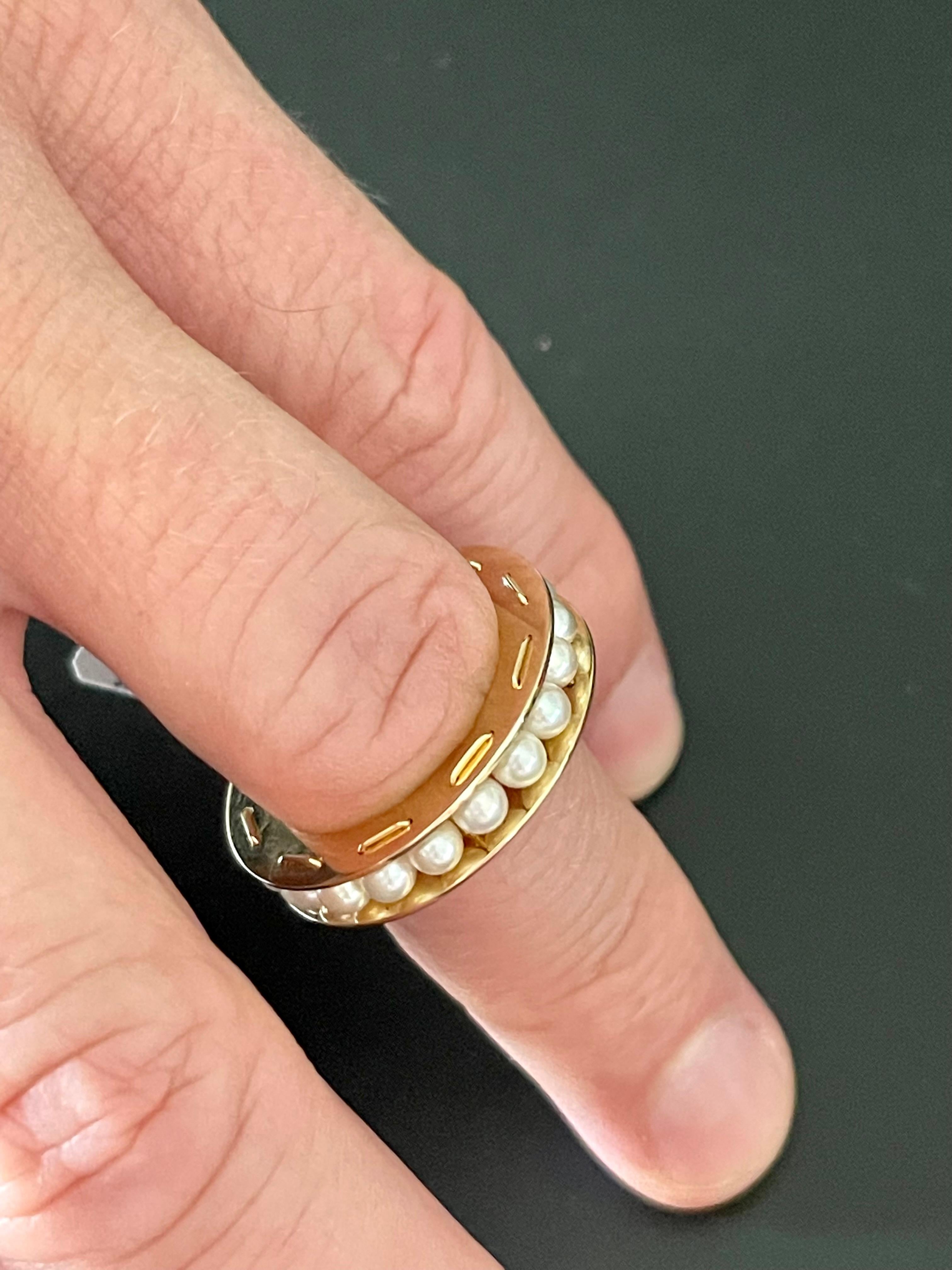 Unusual  18 K yellow Gold Eternity Ring feautruing white cultured Pearls in a channel setting.
The ring is size 55 ( US size 7 1/2 ) 
Masterfully handcrafted piece! Authenticity and money back is guaranteed.
For any enquires, please contact the